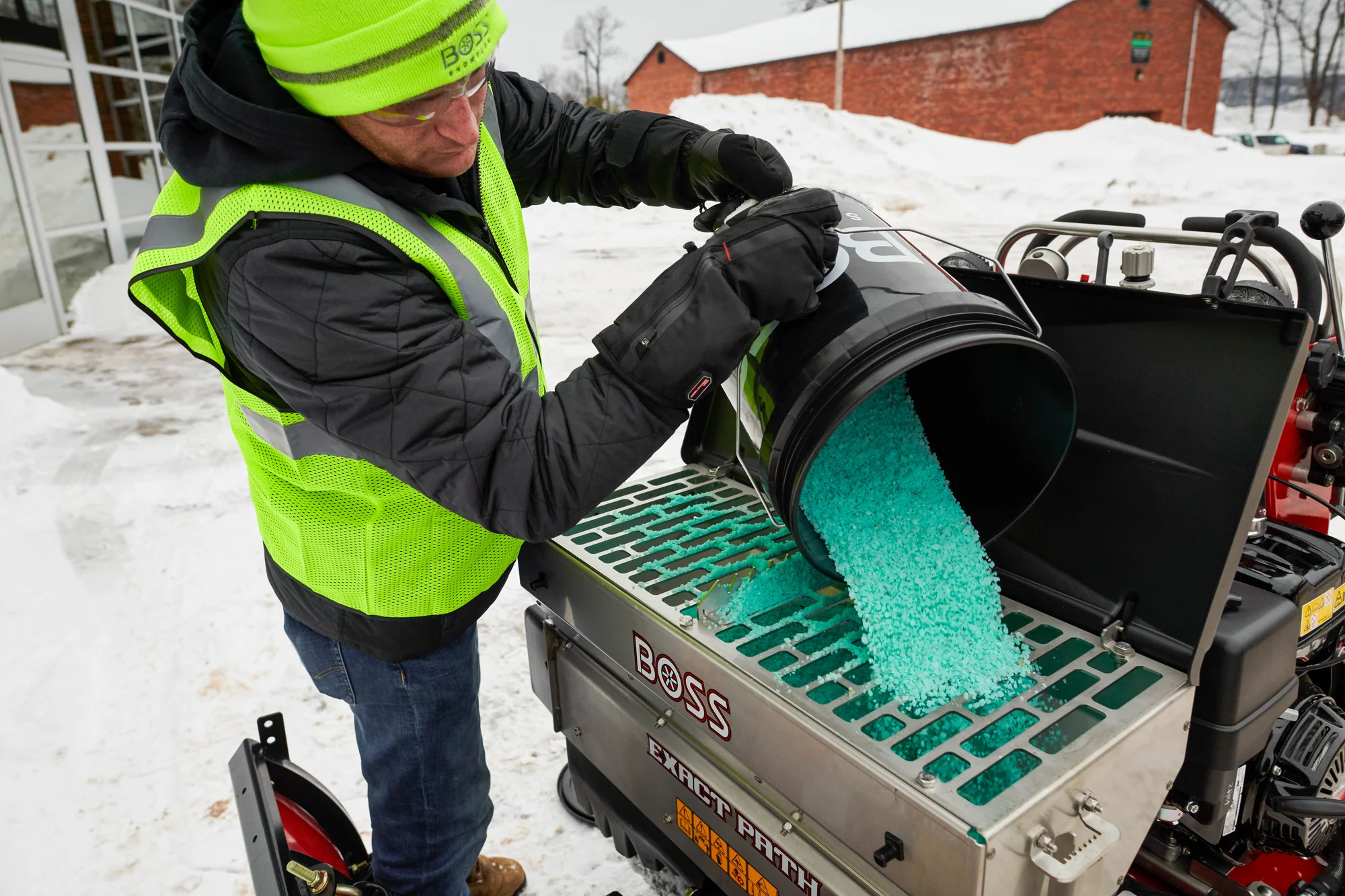Boss Snowrator 24003 Front View Right Man Adding Salt Exact Path product image