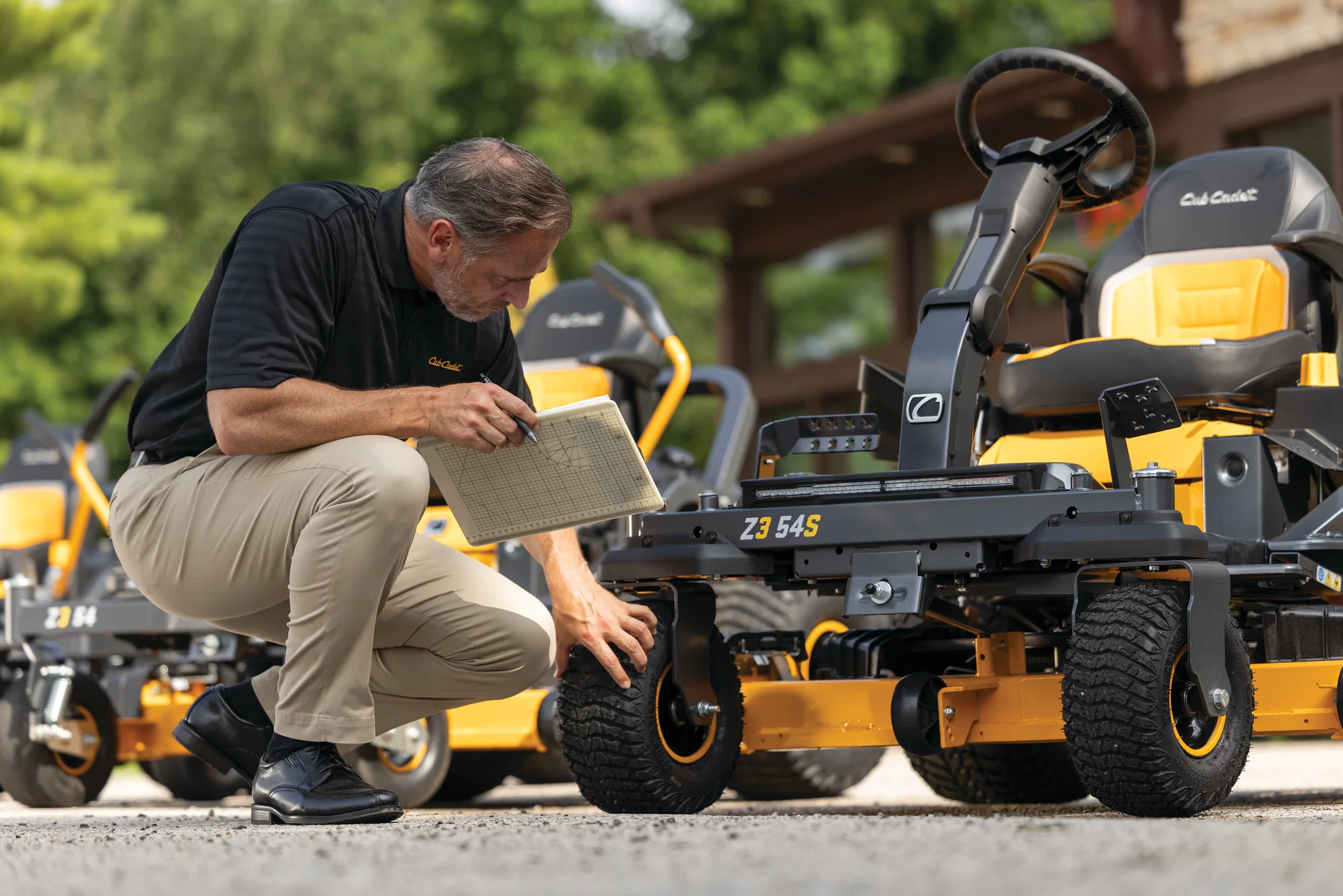 Cub Cadet Ultima Series ZS Zero Turn Rider Z3 54S Cub Cadet Ultima Series Zs Zero Turn Rider Z3 54S Front View Man Checking Tire product image