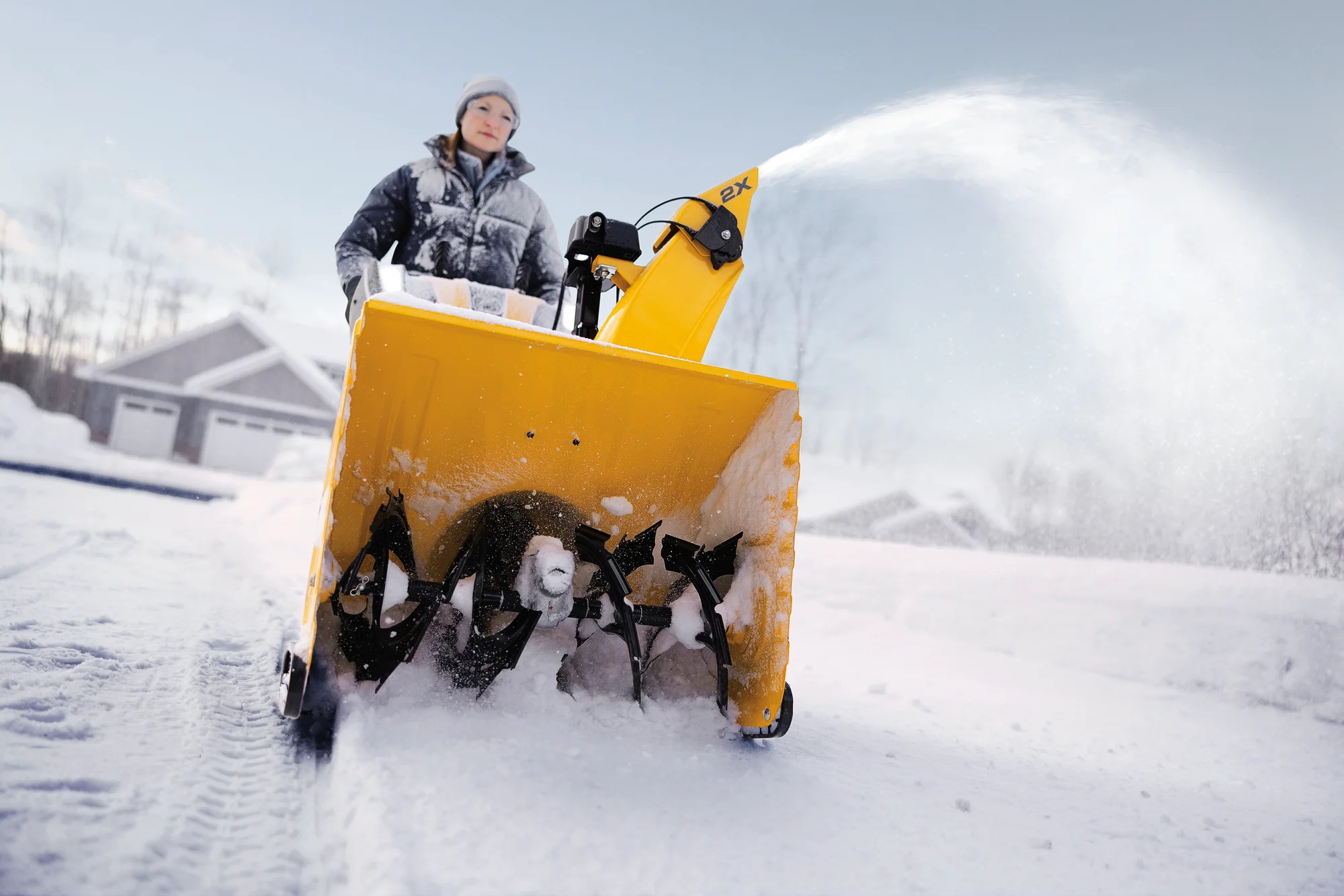 Cubcadet 2X Series Two Stage Snow Blower 2X26 Egov Woman Clearing Snow Wide Angle product image