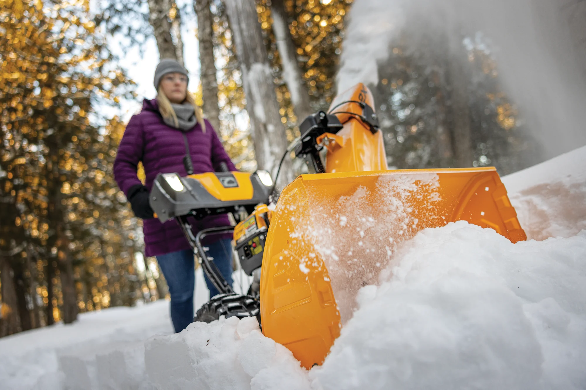 Cubcadet 2X Series Two Stage Snow Blower 2X28 Egov Woman Clearing Driveaway Forest Wide Angle product image