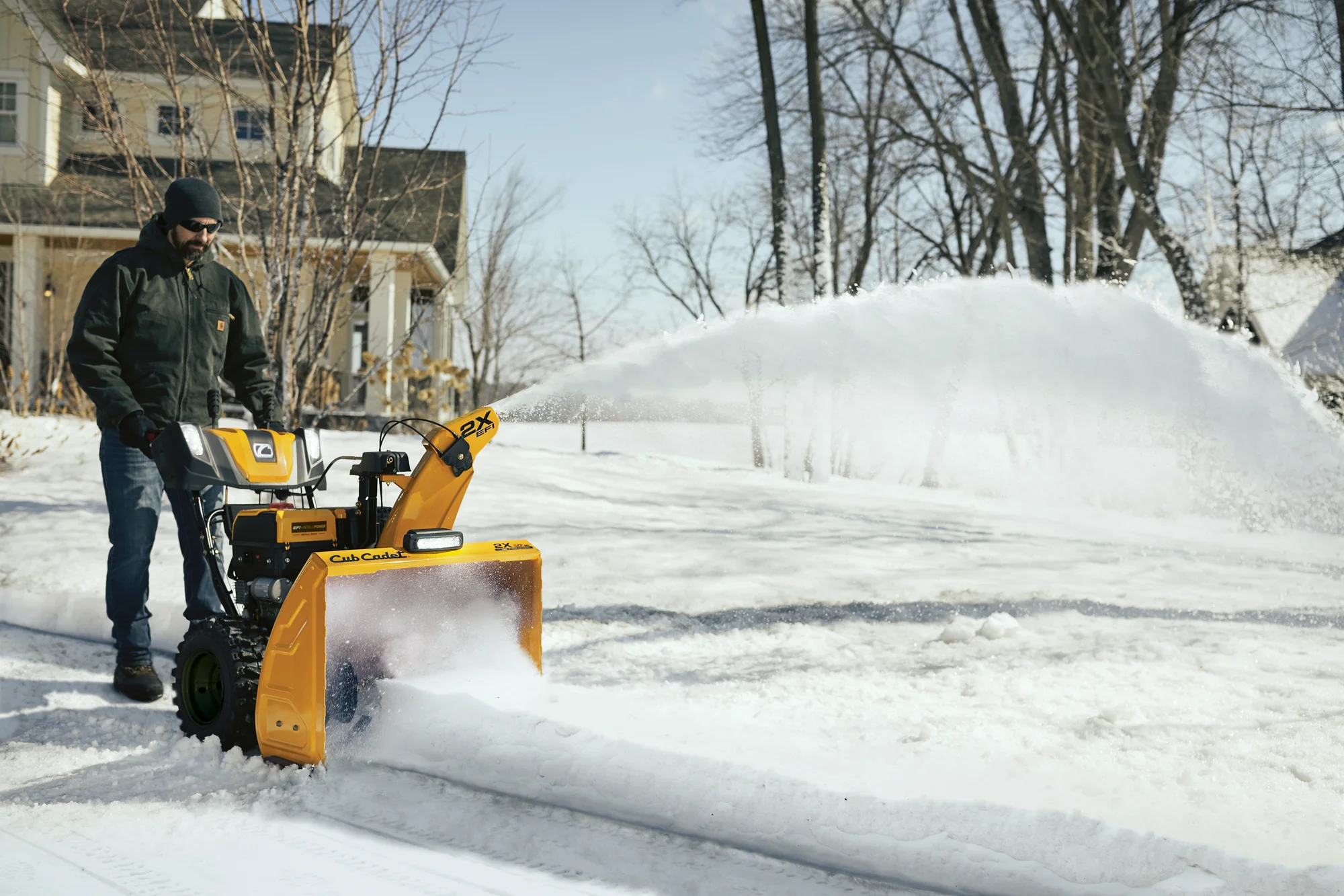 Cubcadet 2X Series Two Stage Snow Blower 2X30 Efi Egov Man Clearing Driveaway Angle View product image