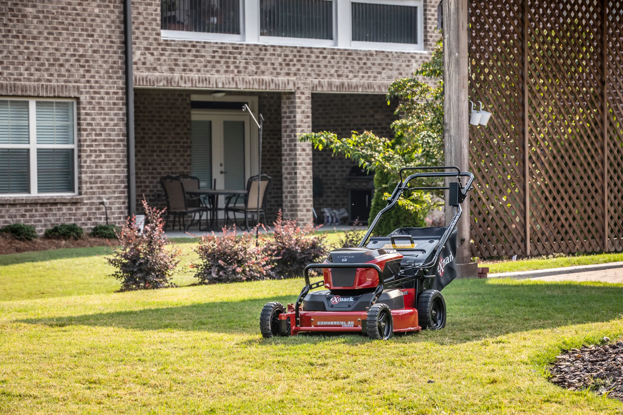 Exmark Commercial 30 V Series Walk Behind Lawn Mower Ecv060B0230010 Mower Parked Backyard By Patio product image