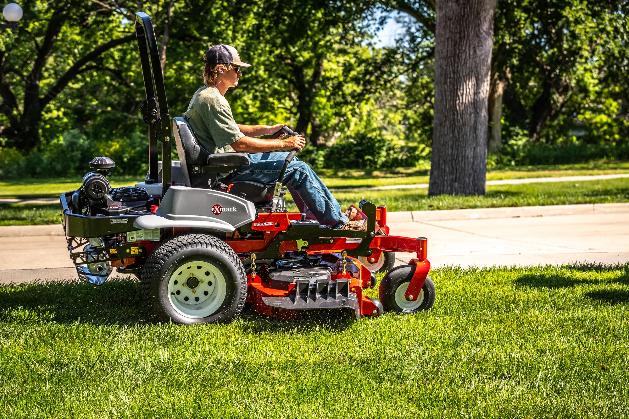 Exmark Lazer Z E Series Zero Turn Rider LRE730GKA48DA3 Exmark Lazer Z E Series Zero Turn Rider Lre730Gka48Da3 Man Mowing Lawn Road product image