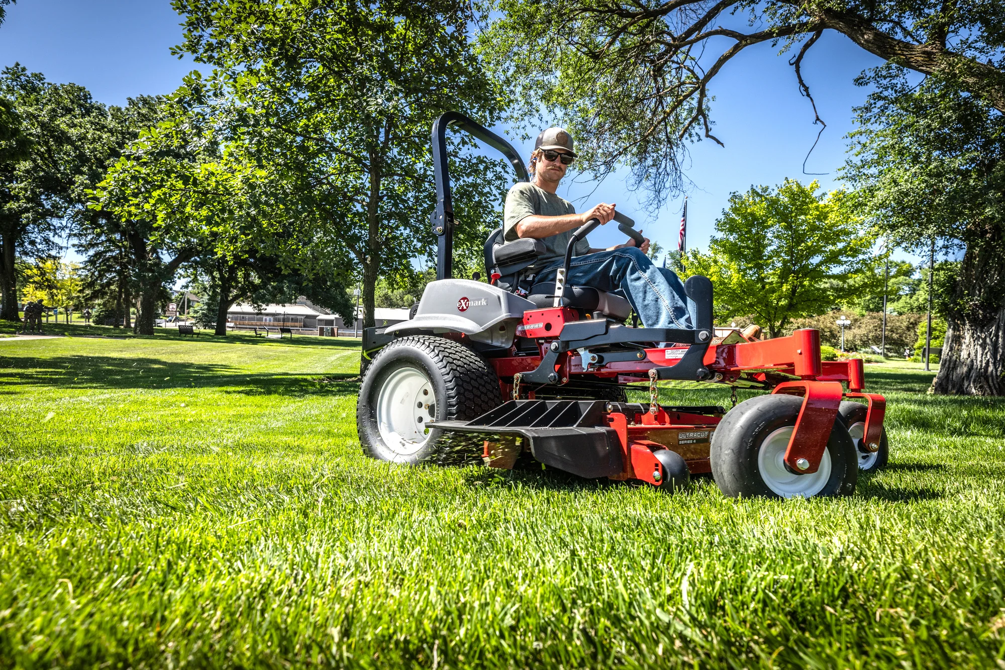 Exmark Lazer Z E Series Zero Turn Rider LRE801GKA604A3 Exmark Lazer Z E Series Zero Turn Rider Lre801Gka604A3 Man Mowing Under Tree Ground View product image