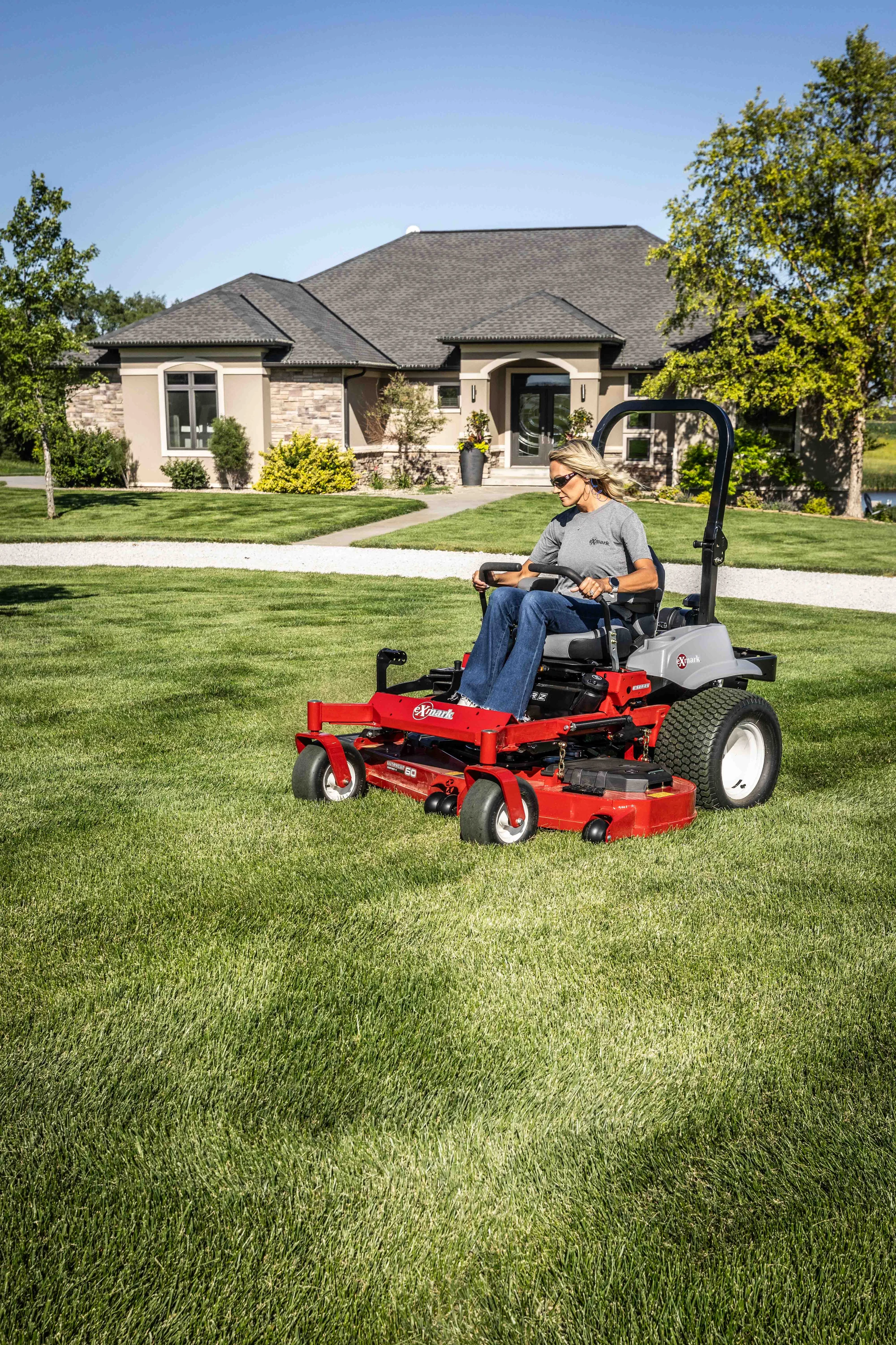 Exmark Lazer Z E Series Zero Turn Rider Lre810Gbv604A3 Woman Mowing Subdivision product image