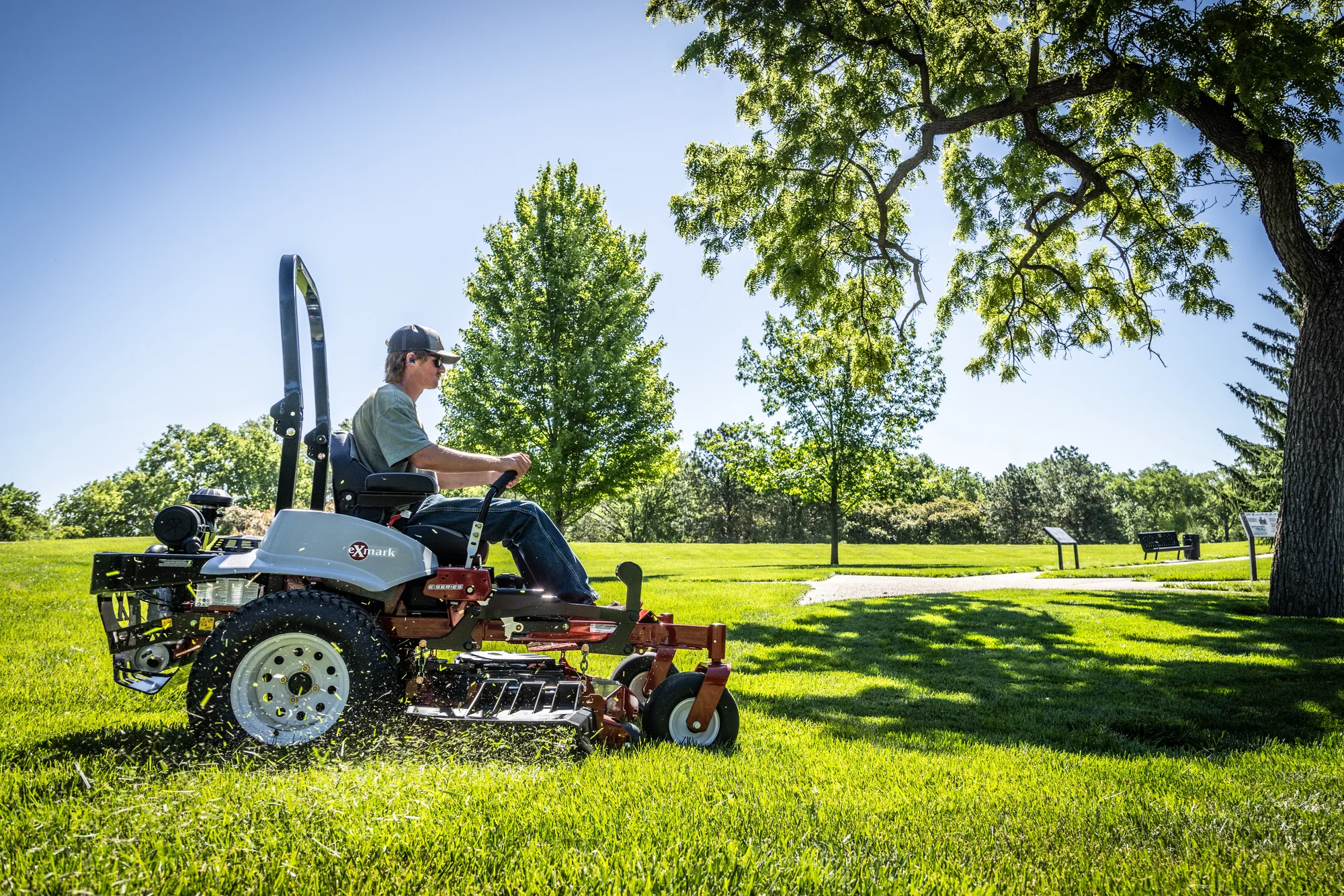 Exmark Lazer Z E Series Zero Turn Rider LRE921GKA604A3 Exmark Lazer Z E Series Zero Turn Rider Lre921Gka604A3 Man Mowing Under Tree product image