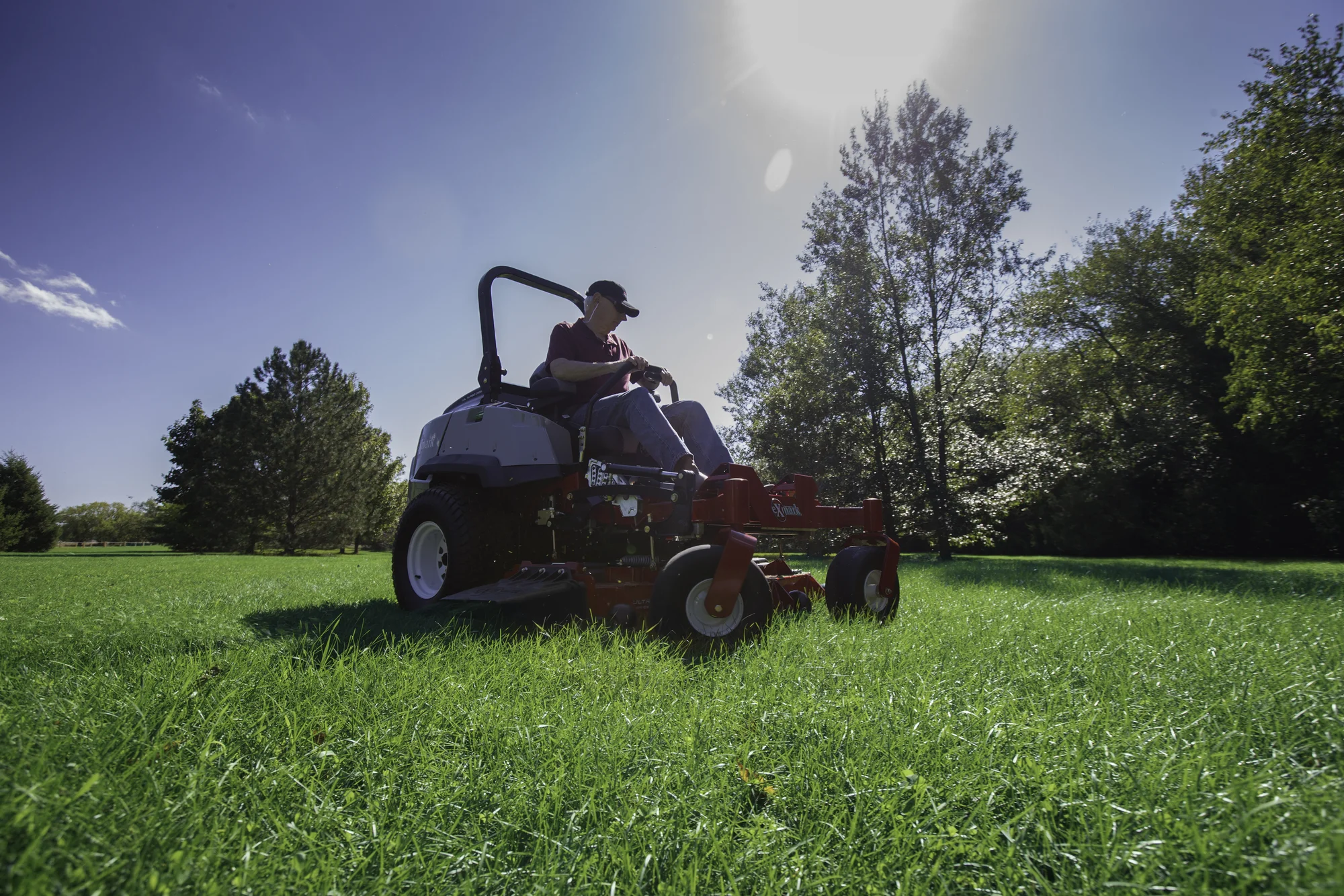 Exmark Lazer Z S Diesel Series Zero Turn Rider LZS80TDYM724W0 Exmark Lazer Z S Diesel Series Zero Turn Rider Lzs80Tdym724W0 Man Cutting Grass Sunshine product image