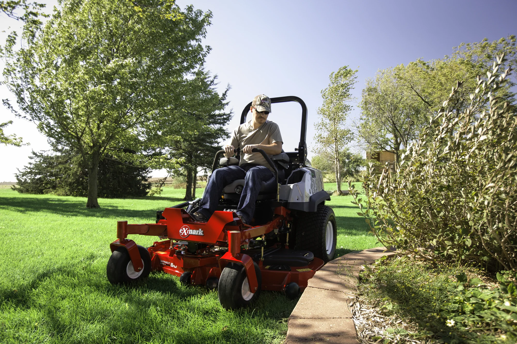 Exmark Lazer Z S Diesel Series Zero Turn Rider Lzs80Tdym724W0 Man Mowing Flower Bed product image