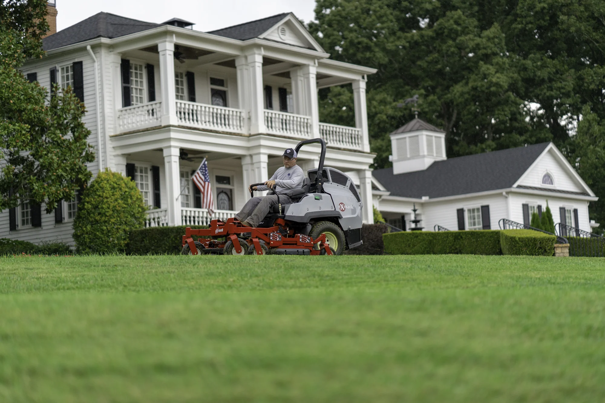 Exmark Lazer Z S Diesel Series Zero Turn Rider LZS88CDYM96RW0 Exmark Lazer Z S Diesel Series Zero Turn Rider Lzs88Cdym96Rw0 Man Mowing Lawn With Estate product image