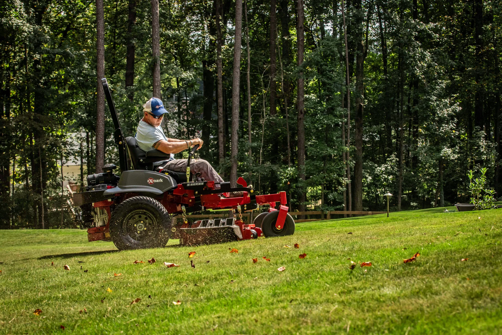 Exmark Lazer Z S Series Zero Turn Rider LRS749AKC524A2 Exmark Lazer Z S Series Zero Turn Rider Lrs749Akc524A2 Man Mowing Lawn Uphill 2 product image