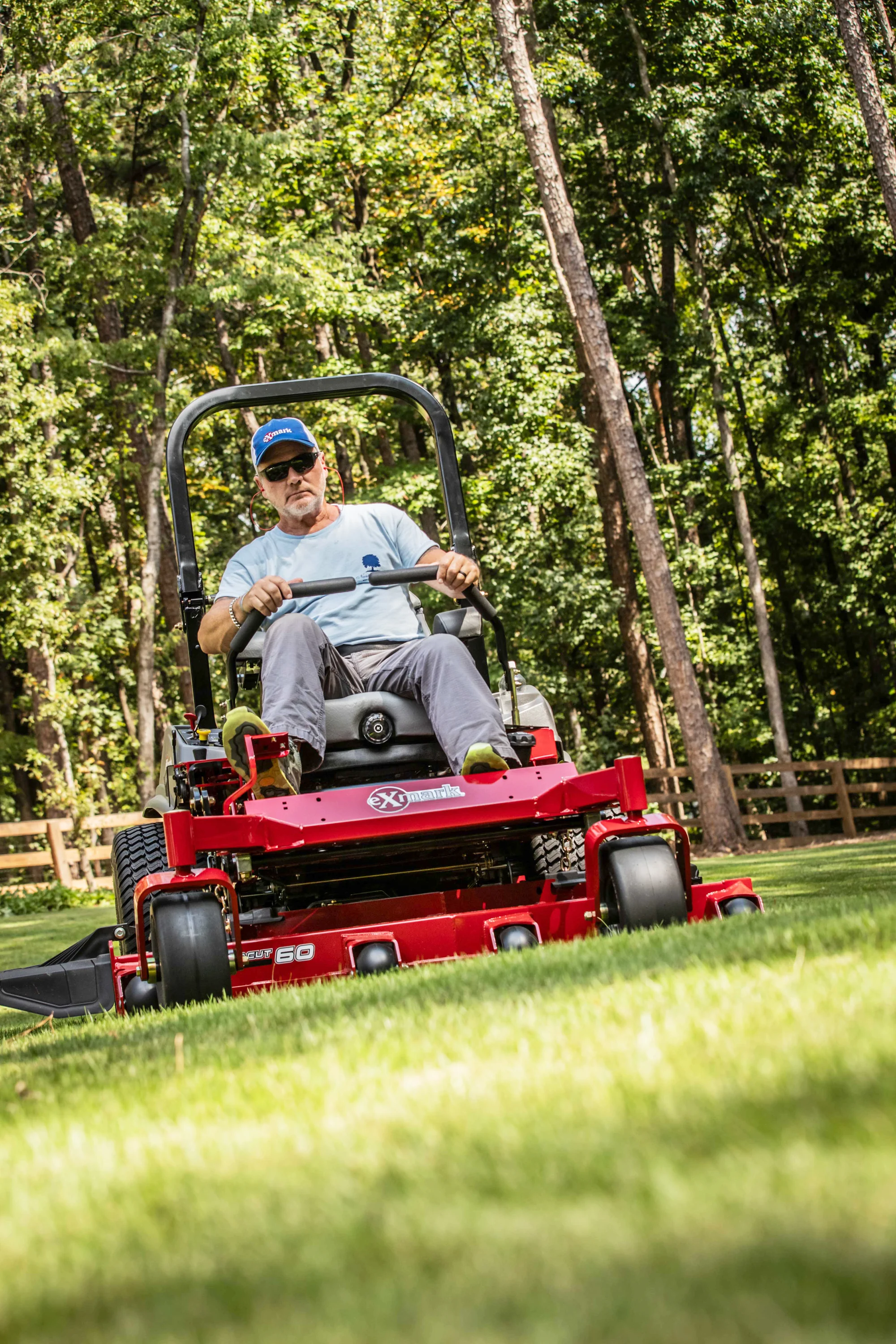 Exmark Lazer Z S Series Zero Turn Rider LRS749AKC724A1 Exmark Lazer Z S Series Zero Turn Rider Lrs749Akc724A1 Man Mowing Lawn Angle product image