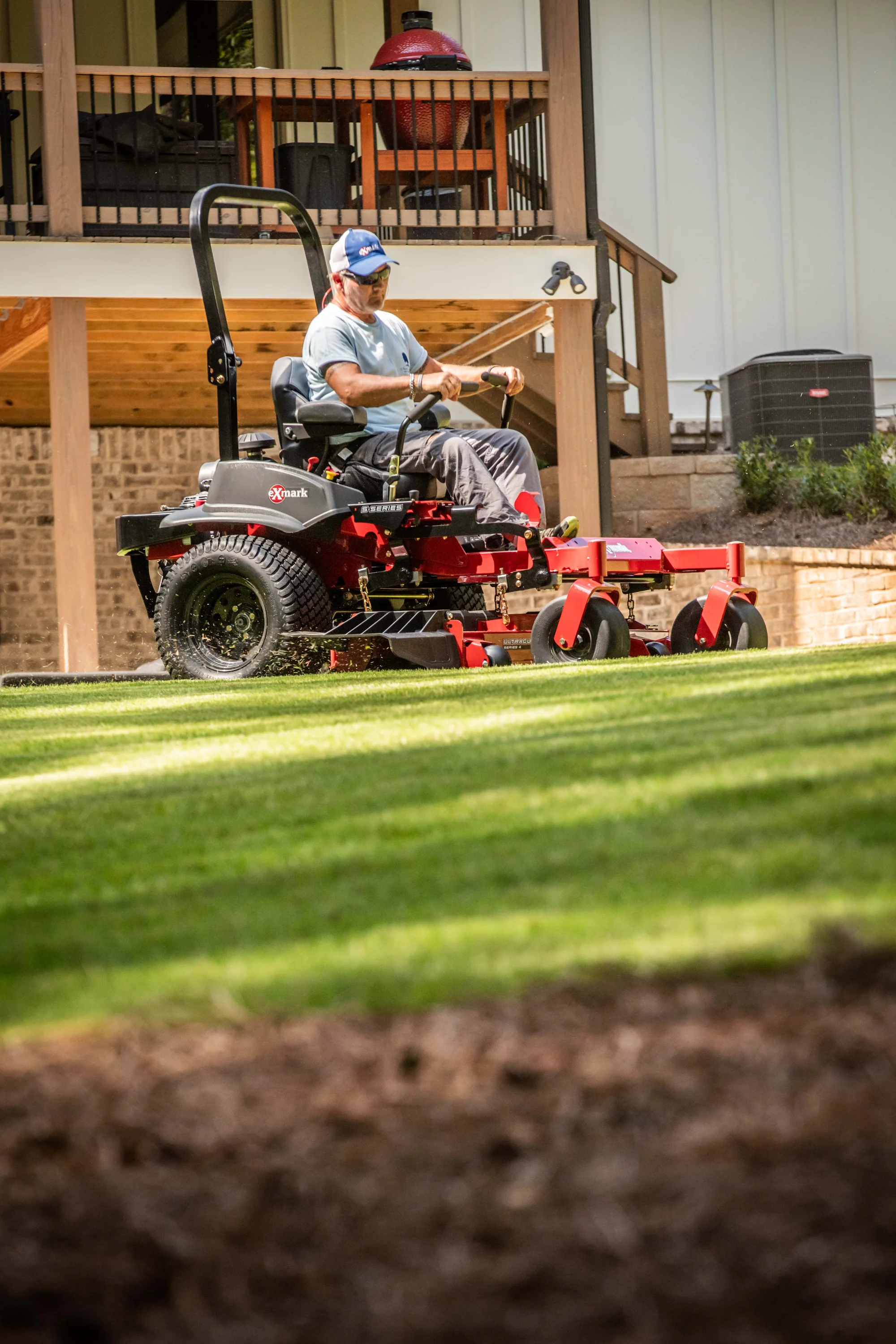 Exmark Lazer Z S Series Zero Turn Rider Lrs801Gka524A1 Man Mowing Lawn Ground View product image