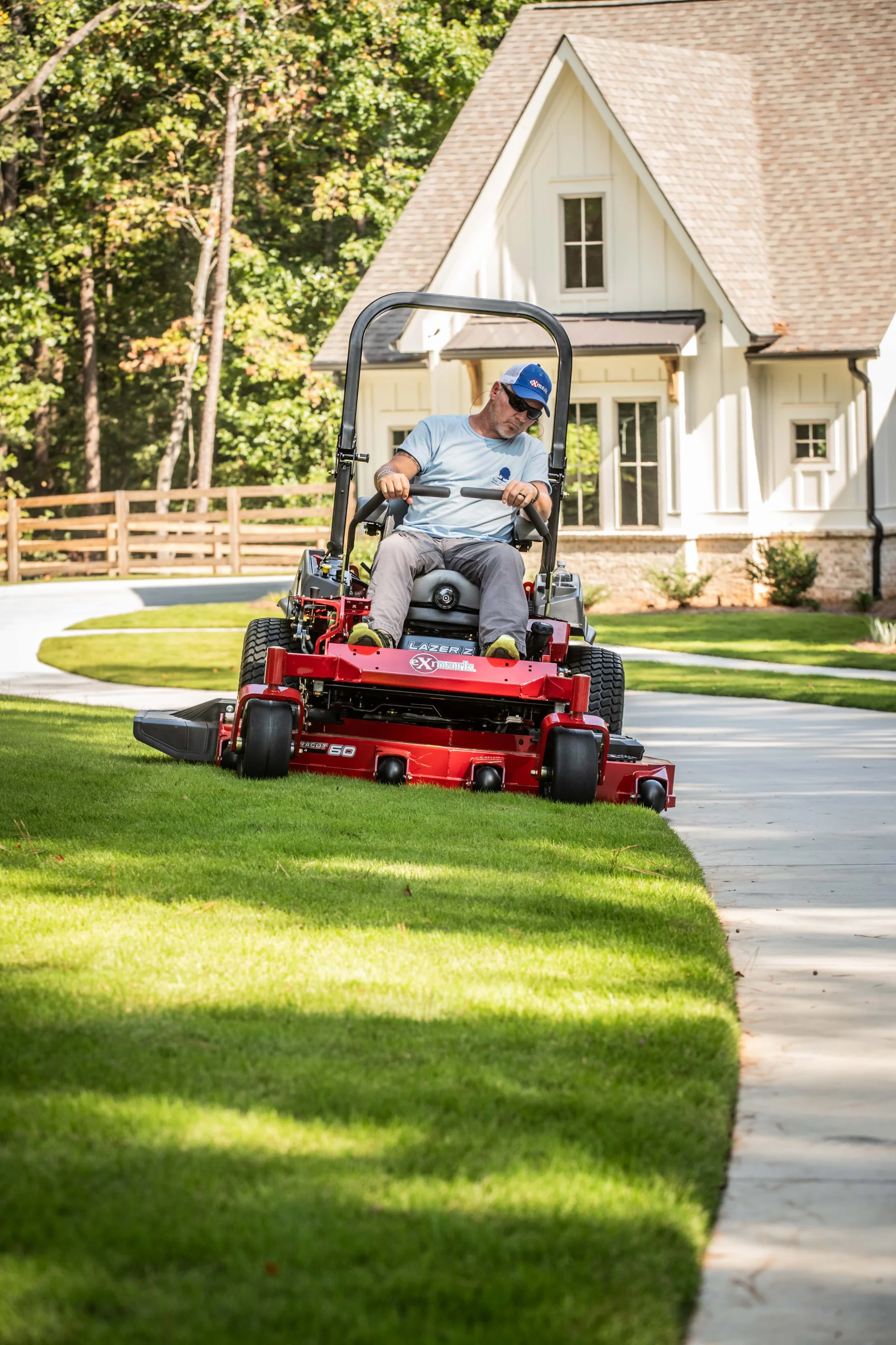 Exmark Lazer Z S Series Zero Turn Rider LRS801GKA72RA1 Exmark Lazer Z S Series Zero Turn Rider Lrs801Gka72Ra1 Man Mowing Lawn Sidewalk product image