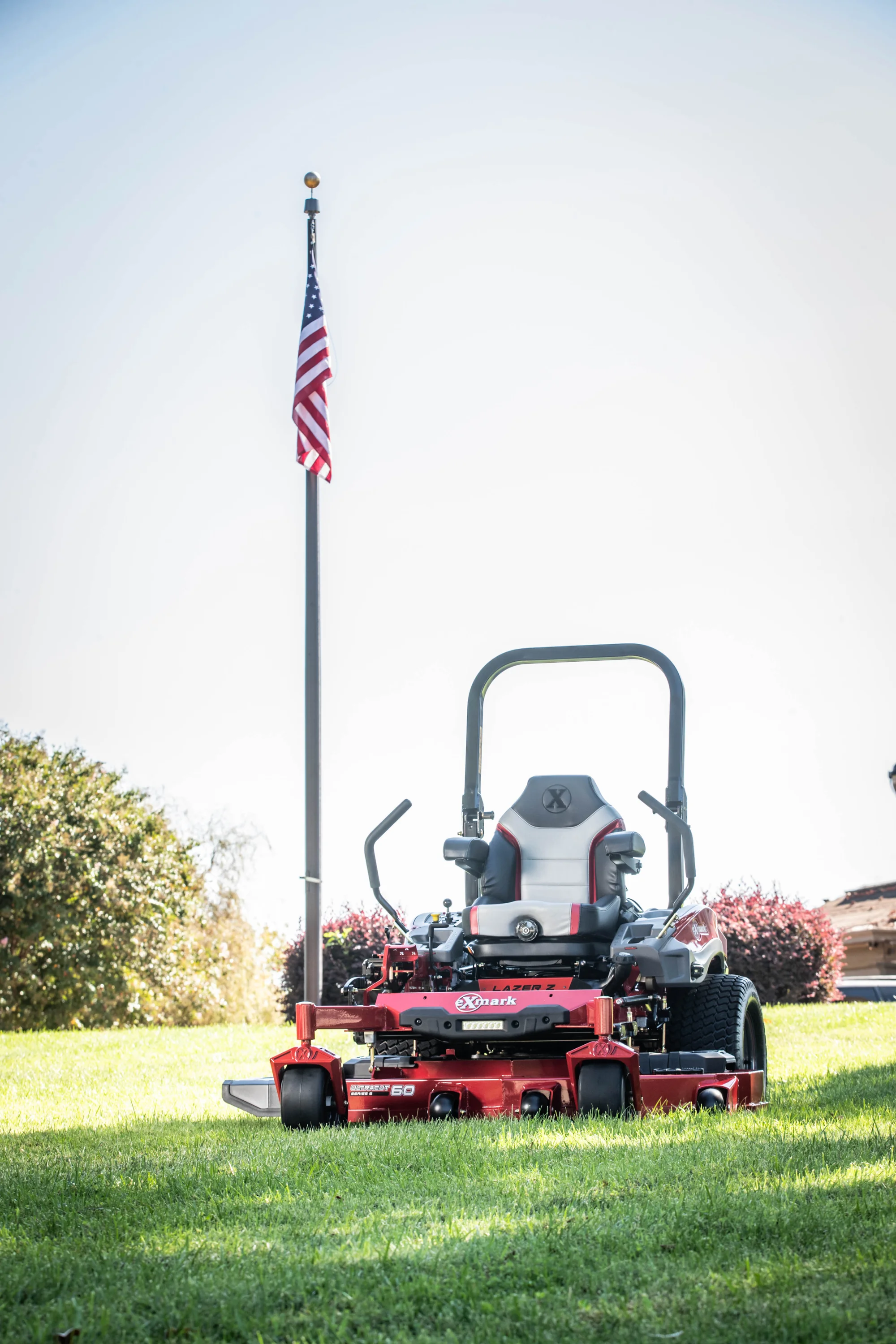 Exmark Lazer Z X Series Zero Turn Rider Lrx850Gka526Q1 Mower In Front Of Flag Ground View product image