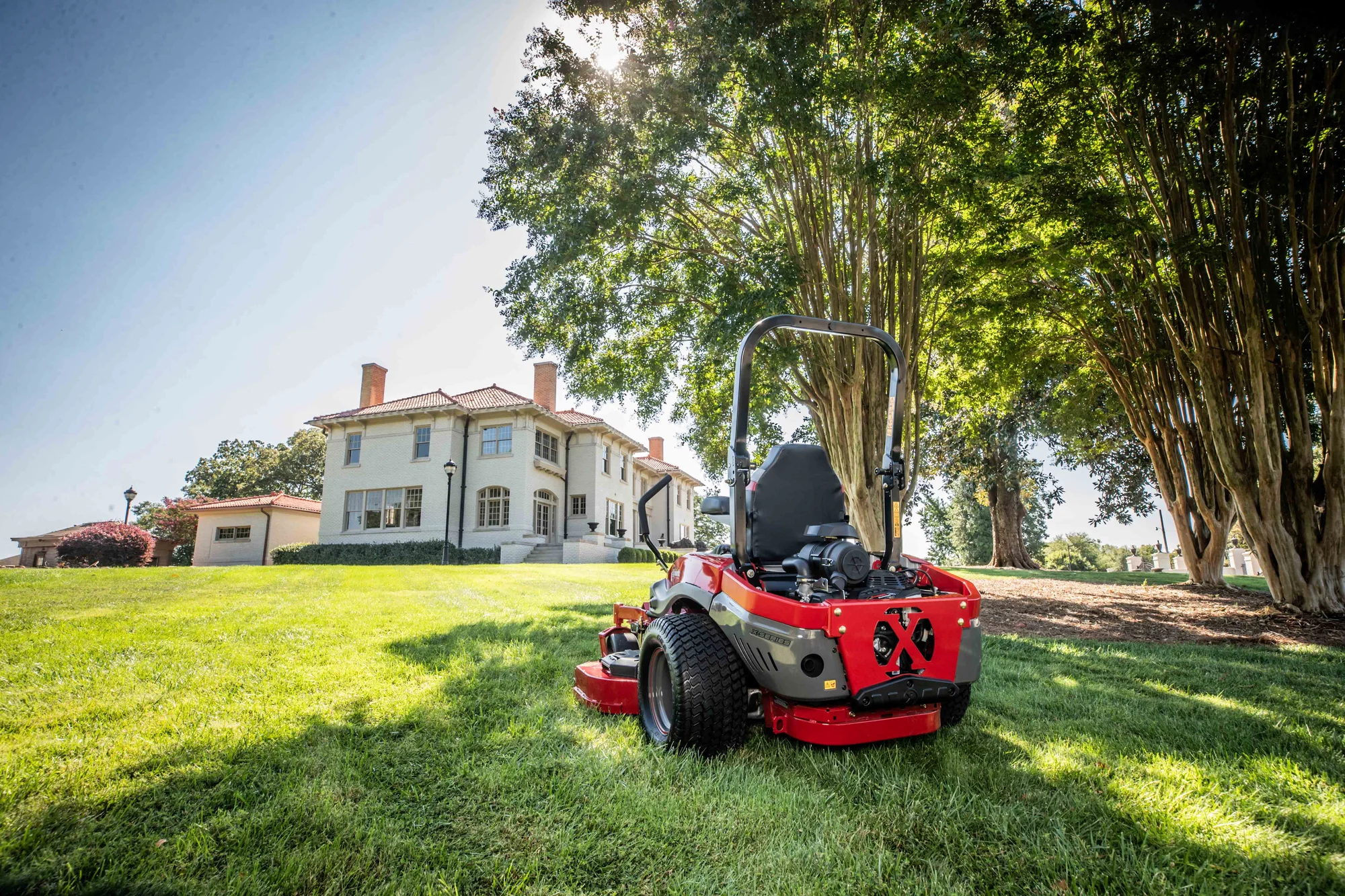 Exmark Lazer Z X Series Zero Turn Rider Lrx850Gka526Q1 Mower Lawn House Back Ground View product image
