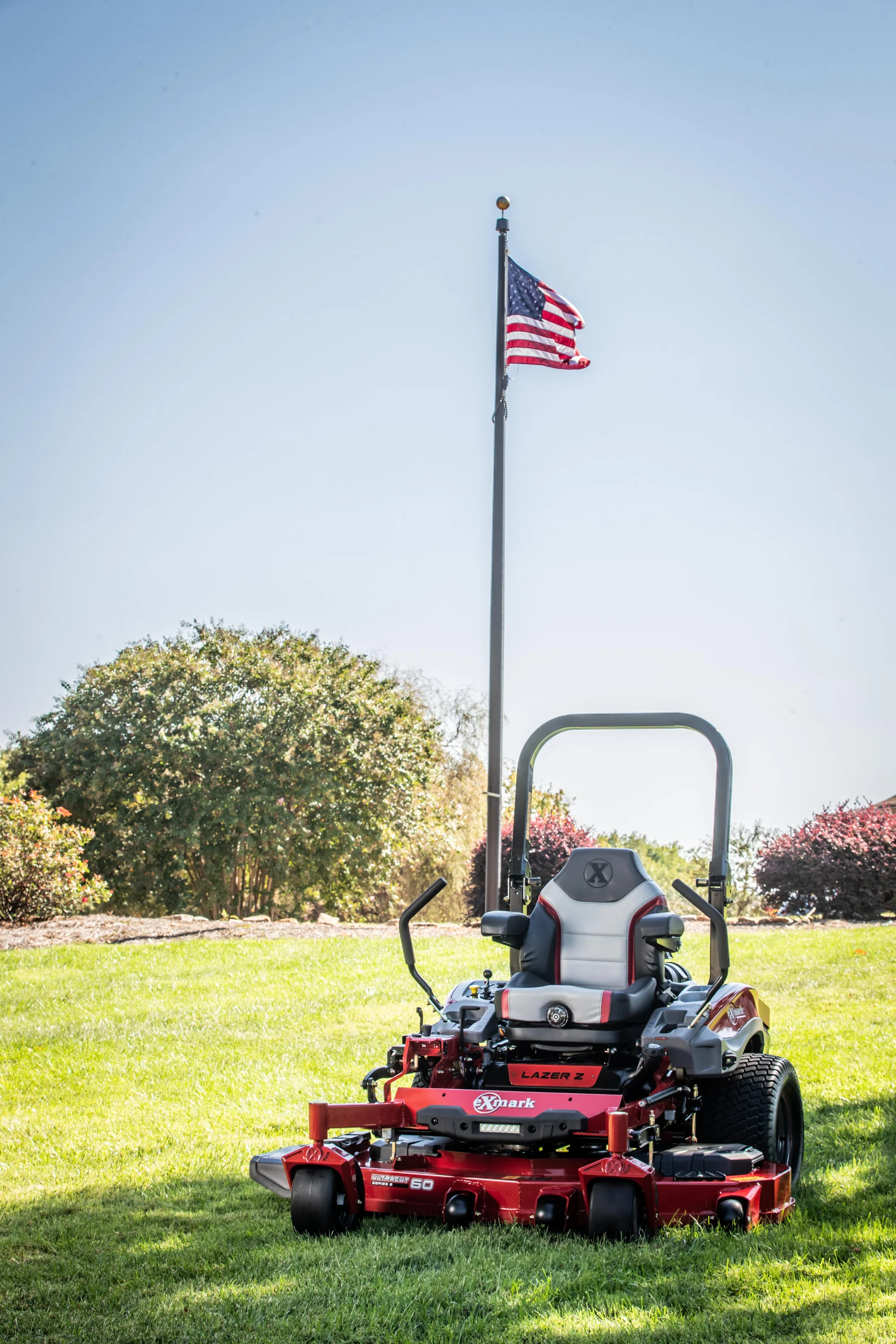 Exmark Lazer Z X Series Zero Turn Rider Lrx921Gka726Q1 Mower In Front Of Flag product image