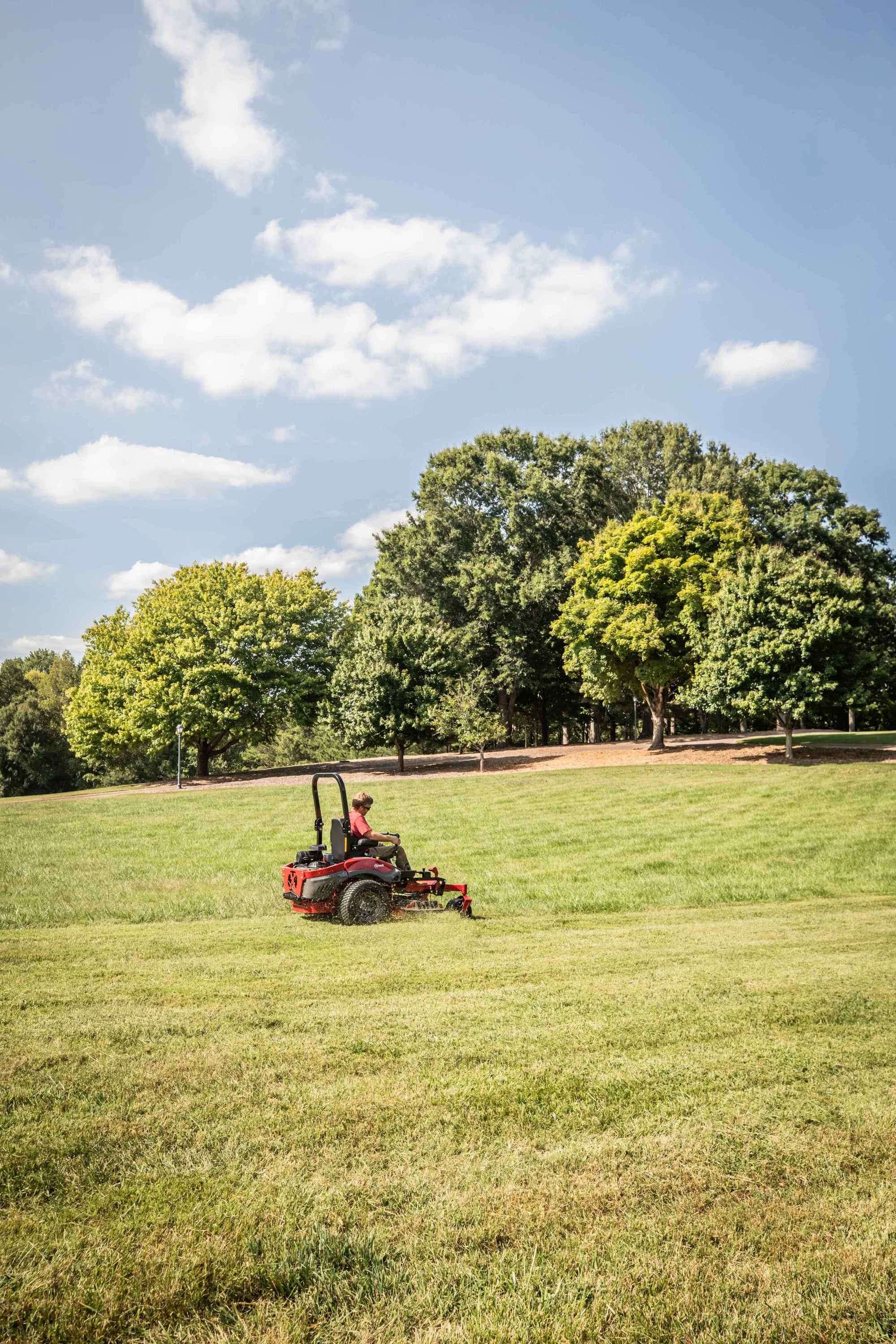 Exmark Lazer Z X Series Zero Turn Rider LRX993EBX726Q1 Exmark Lazer Z X Series Zero Turn Rider Lrx993Ebx726Q1 Man Cutting Tall Grass product image