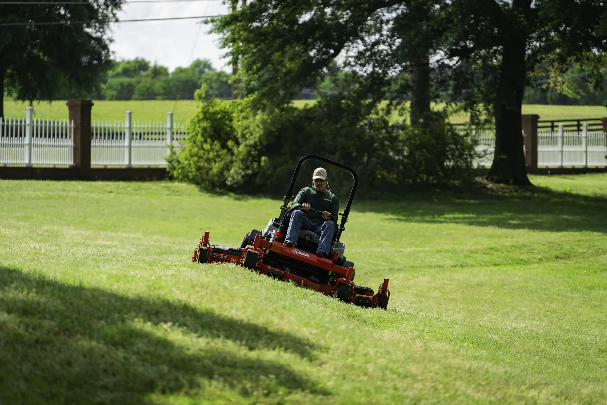 Exmark Lazer Z X Series Zero Turn Rider Lzx980Ekc606R1 Man Mowing Hill product image
