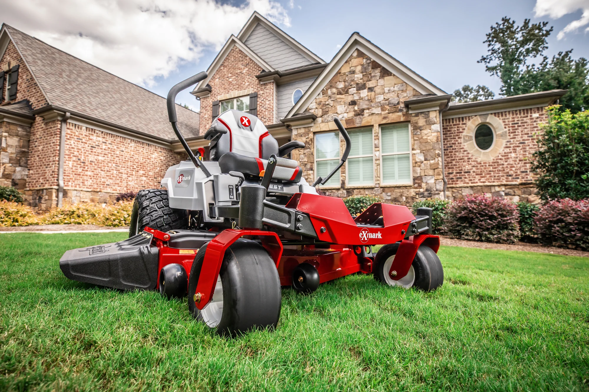 Exmark Quest X Series Zero Turn Rider Qzx735Gkc48300 Wide Angle Mower In Front Of House product image