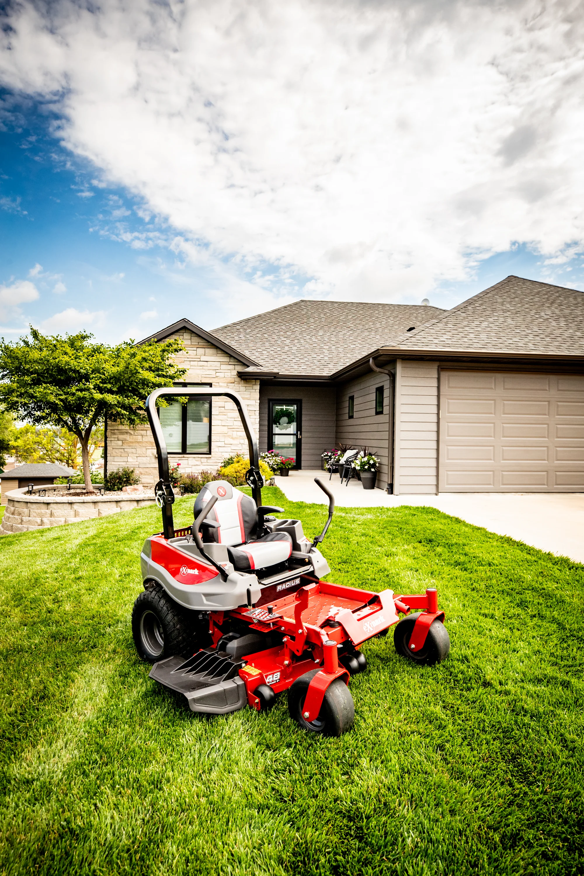 Exmark Radius E Series Zero Turn Rider RDE691GKA48200 Exmark Radius E Series Zero Turn Rider Rde691Gka48200 Woman On Mower Wide Angle Front View product image
