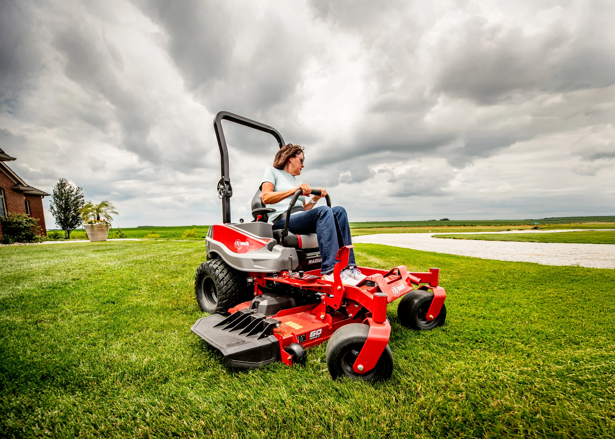 Exmark Radius E Series Zero Turn Rider RDE730GKA60200 Exmark Radius E Series Zero Turn Rider Rde730Gka60200 Woman On Mower Wide Angle product image