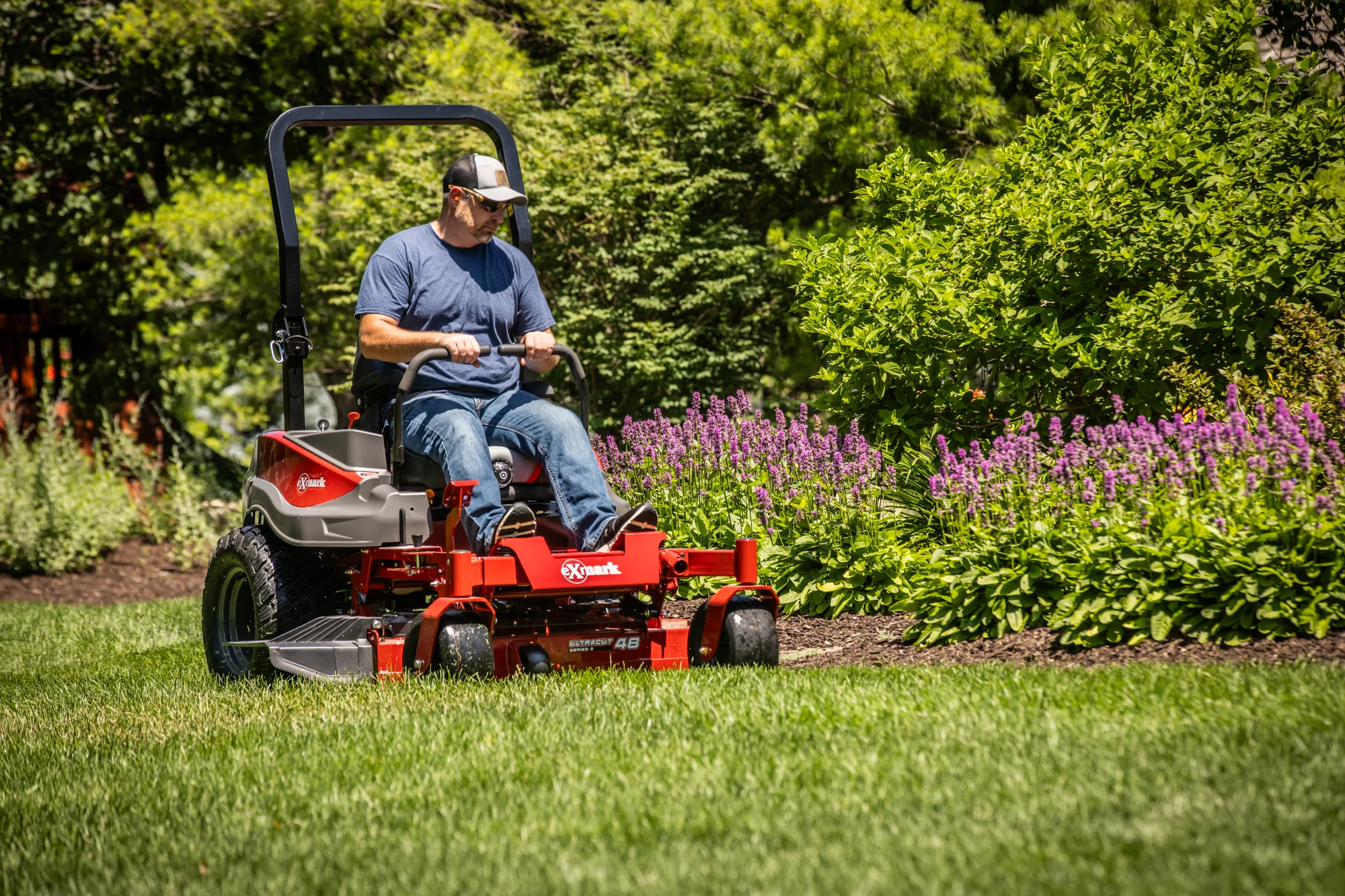 Exmark Radius S Series Zero Turn Rider Rds691Gka523A3 Man Cutting Grass Flowerbed product image