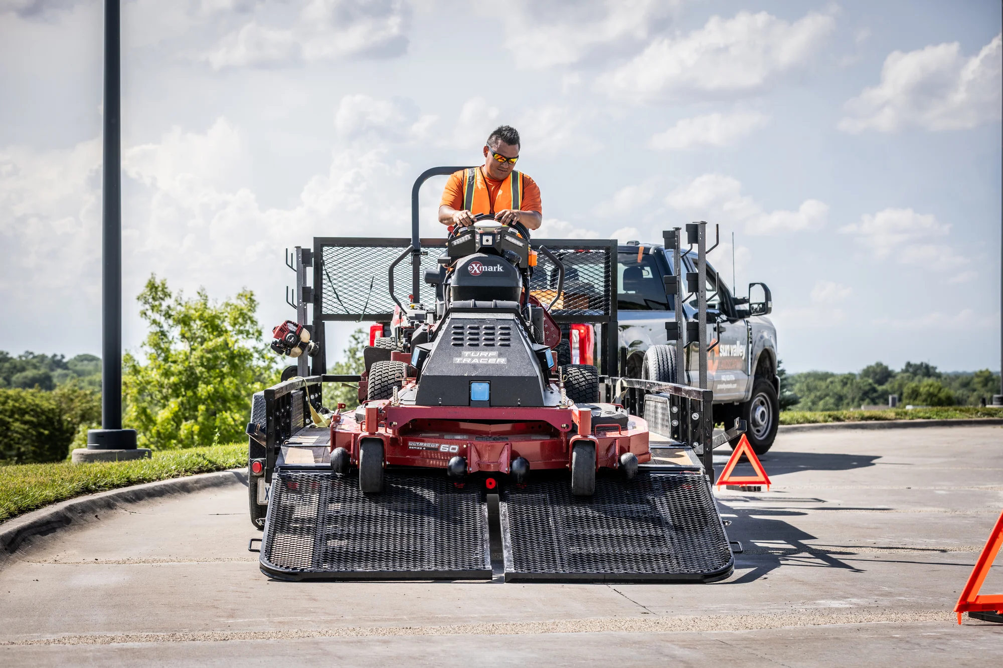 Exmark Turf Tracer Autonomous Series Walk Behind Lawn Mower Tta749Akc604N0 Man Unloading Mower Closeup product image