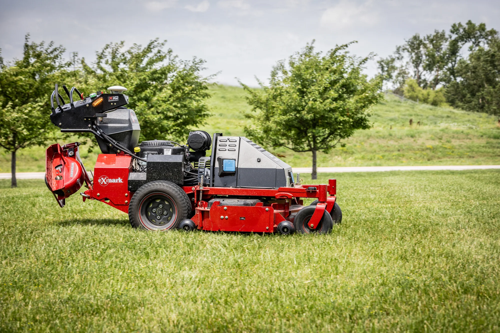 Exmark Turf Tracer Autonomous Series Walk Behind Lawn Mower Tta749Akc604N0 Mower Grass Side View product image
