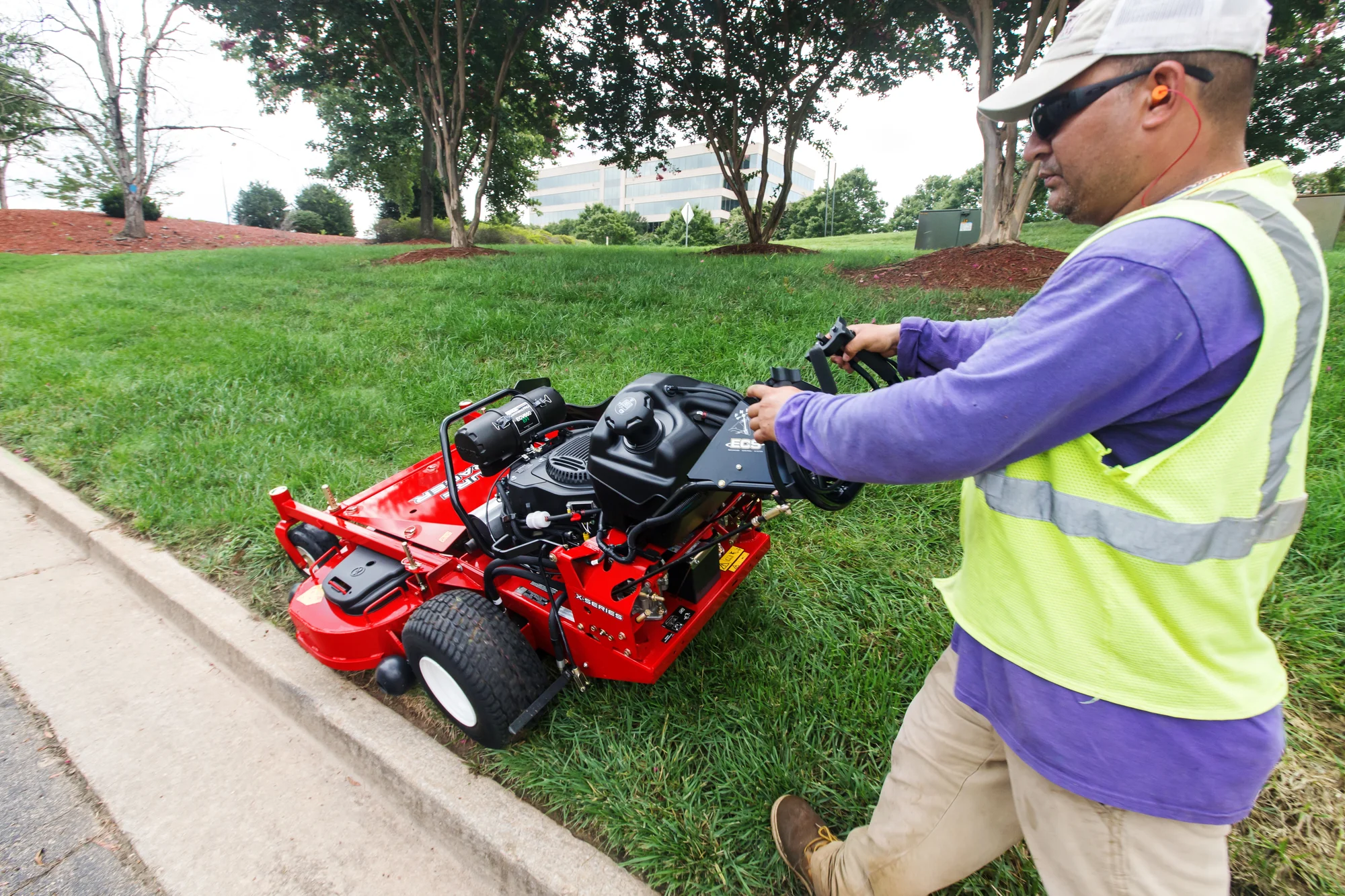 Exmark Turf Tracer X Series Lawn Mower Ttx691Gka60400 Man Mowing Curb product image