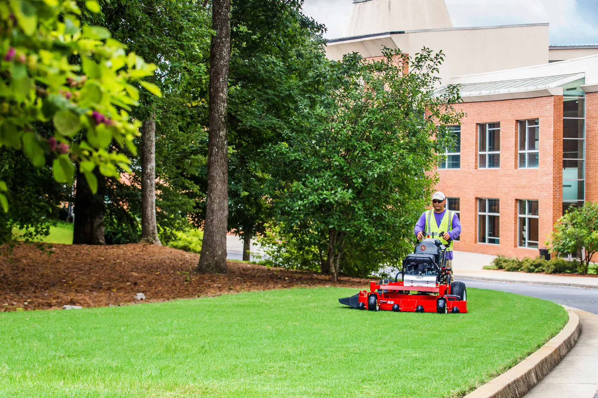 Exmark Turf Tracer X Series Lawn Mower TTX691GKA60400 Exmark Turf Tracer X Series Lawn Mower Ttx691Gka60400 Man Mowing Distant product image