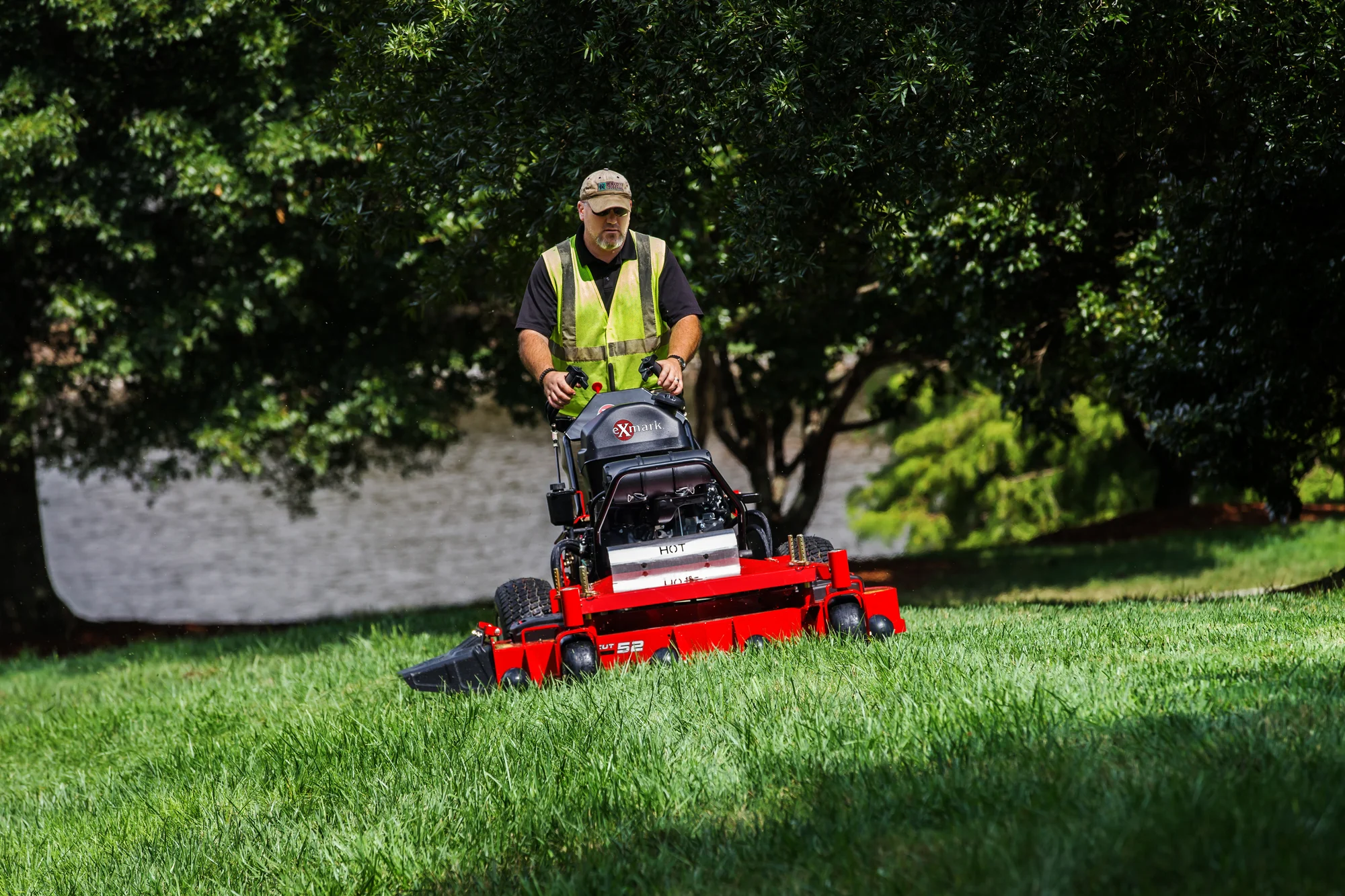 Exmark Turf Tracer X Series Lawn Mower TTX691GKA60400 Exmark Turf Tracer X Series Lawn Mower Ttx691Gka60400 Man Uphill Mower Trees product image