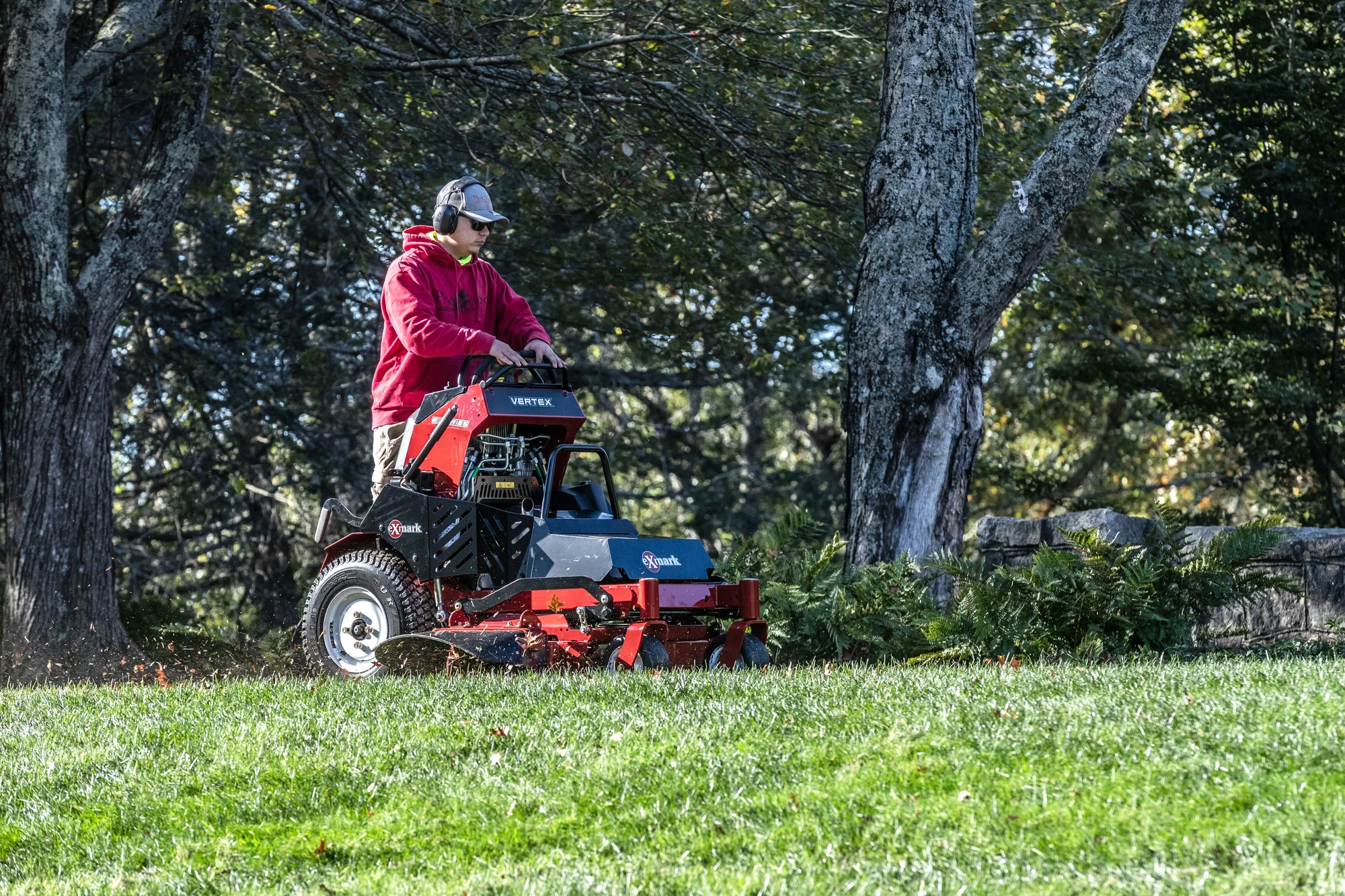 Exmark Vertex E Series Stand On Lawn Mower Vxe600Gka32300 Man Mowing Forest Hill product image