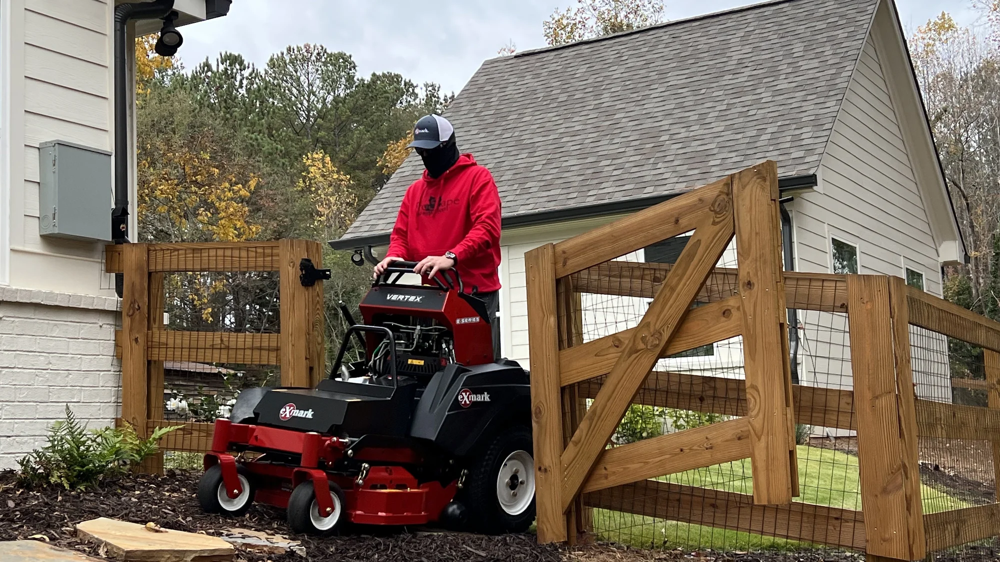 Exmark Vertex E Series Stand On Lawn Mower Vxe600Gka36300 Landscaper Mowing Near Fence product image