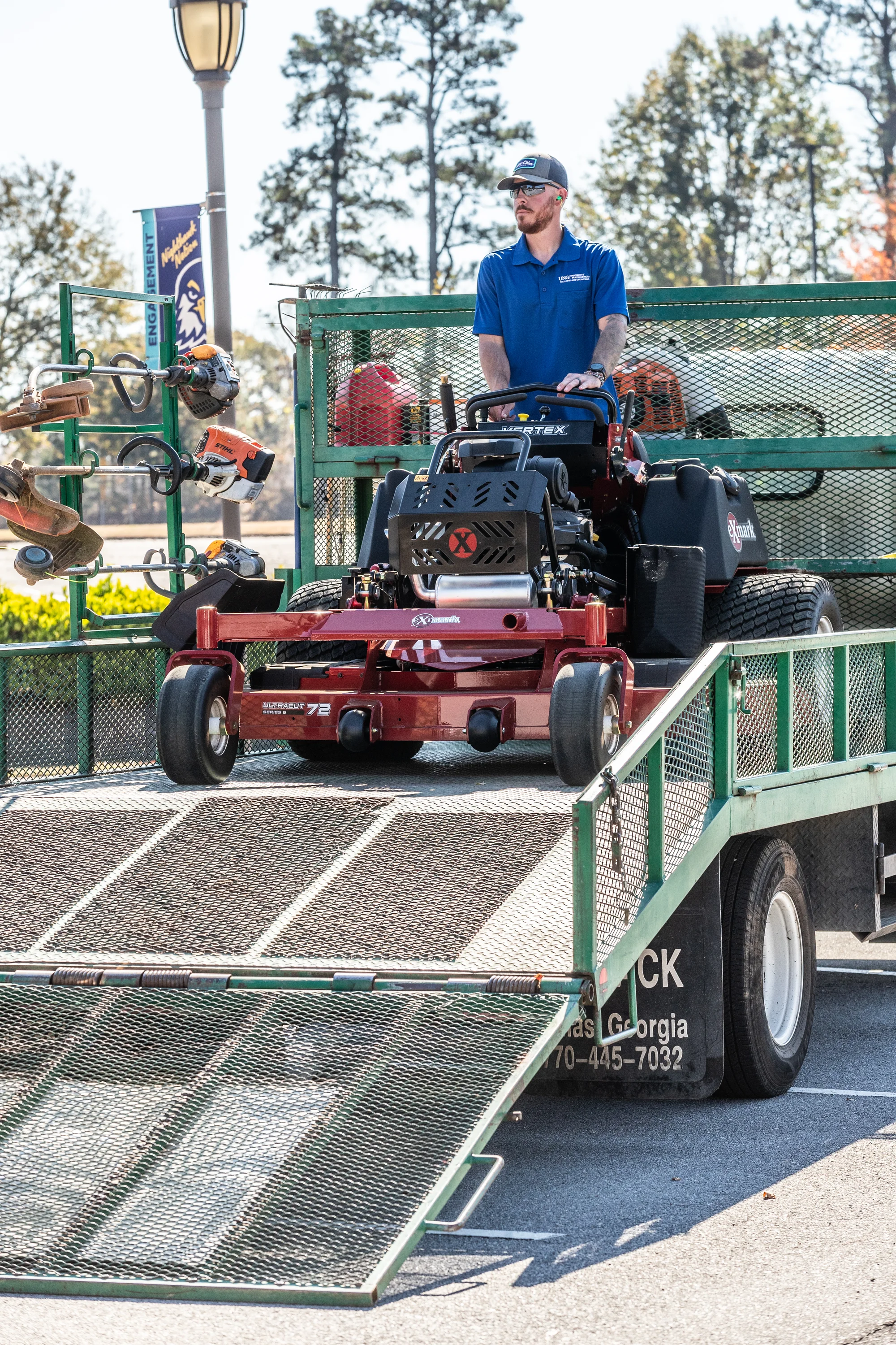 Exmark Vertex X Series Stand On Lawn Mower Vxx999Eka60600 Landscaper Unloading Mower Posing product image