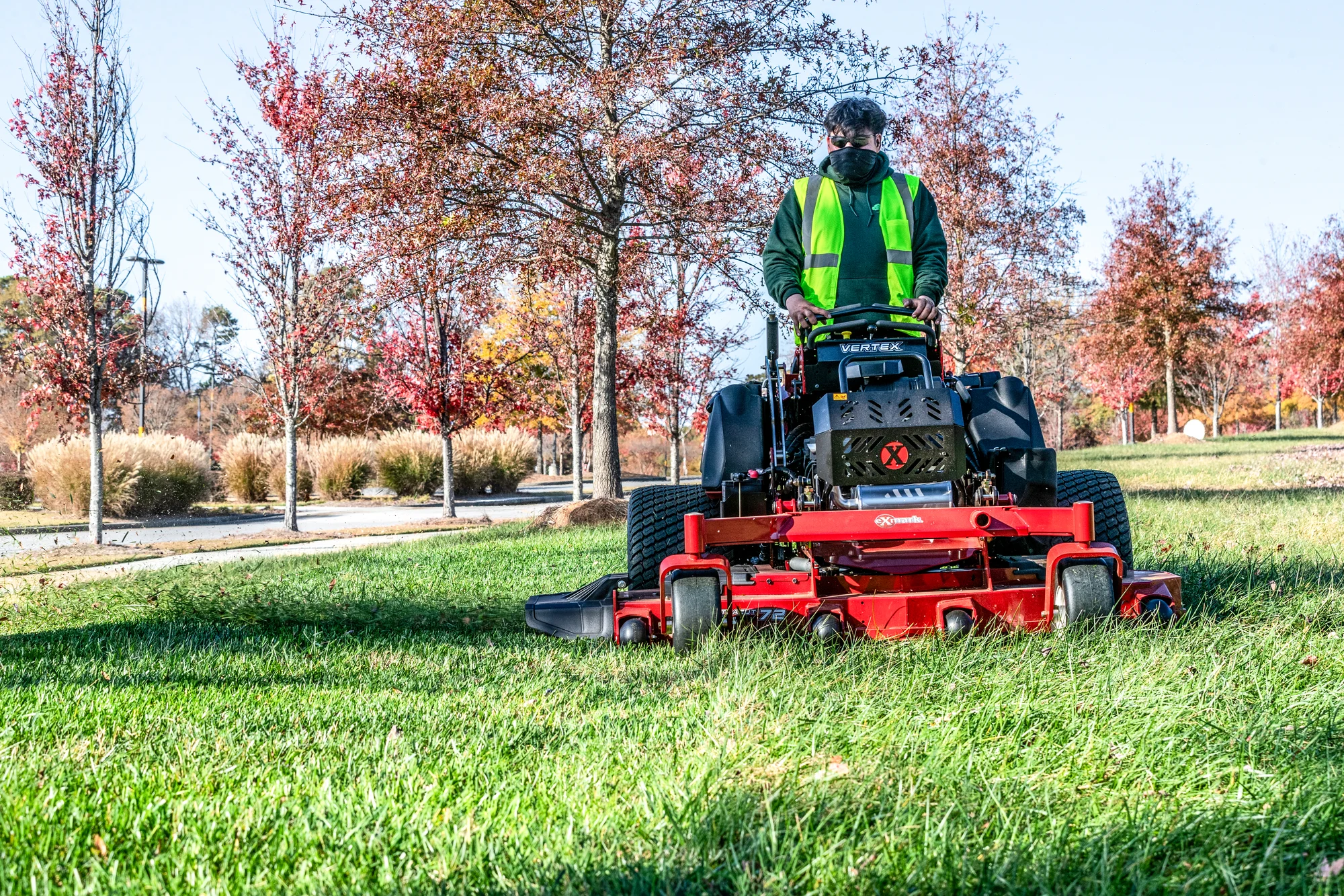 Exmark Vertex X Series Stand On Lawn Mower Vxx999Eka60600 Man With Mask On Mower product image