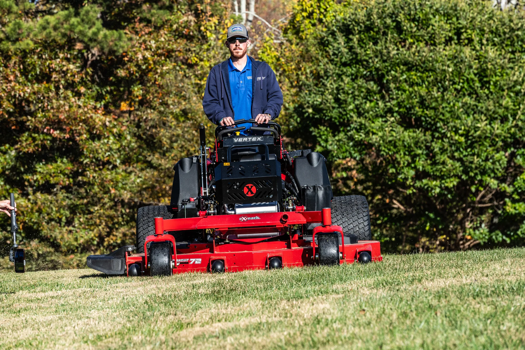 Exmark Vertex X Series Stand On Lawn Mower Vxx999Eka72600 Front View Landscaper Mowing Property Closeup product image