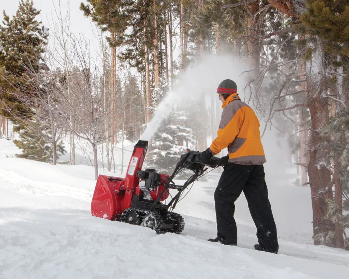 Honda Atd Series Two Stage Snow Blower Hss724Aatd Man Clearing Snow Side View product image