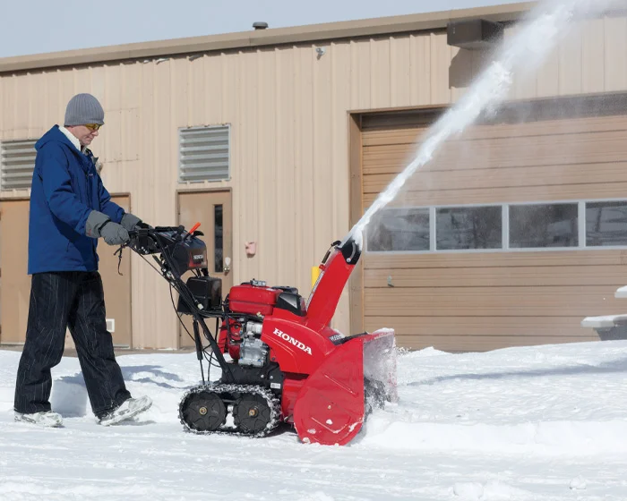 Honda Atd Series Two Stage Snow Blower Hss928Aatd Man Clearing Snow Side View product image