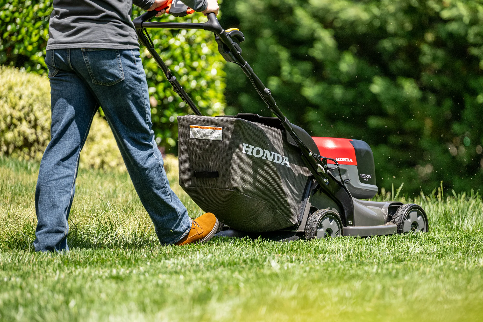 Honda Hrx Bv Battery Powered Walk Behind Lawn Mower Back View Left Closeup Man Cutting Lawn product image