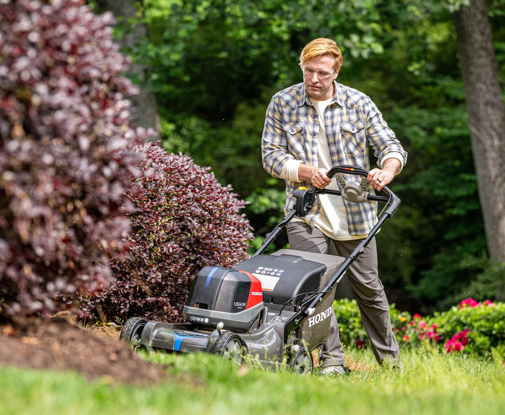 Honda Hrx Bv Battery Powered Walk Behind Lawn Mower Front View Right Man Cutting Lawn product image