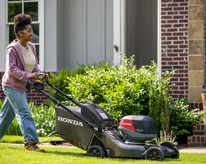 Honda HRX-BV Battery Powered Walk Behind Lawn Mower HRX217VKA4 Honda Hrx Bv Battery Powered Walk Behind Lawn Mower Hrx217Vka4 Woman Pushing Mower product image