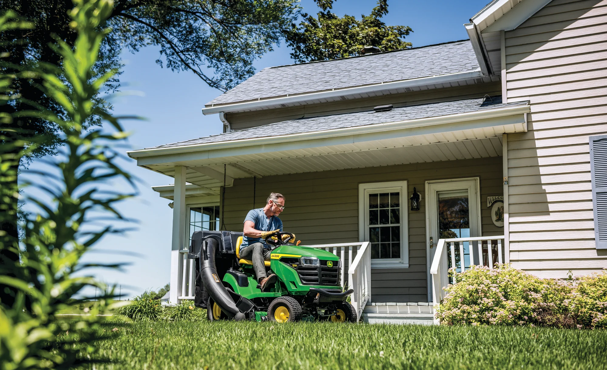 John Deere Lawn Tractor S220 Series 42 Side View Man Mowing Lawn In Front Of House product image