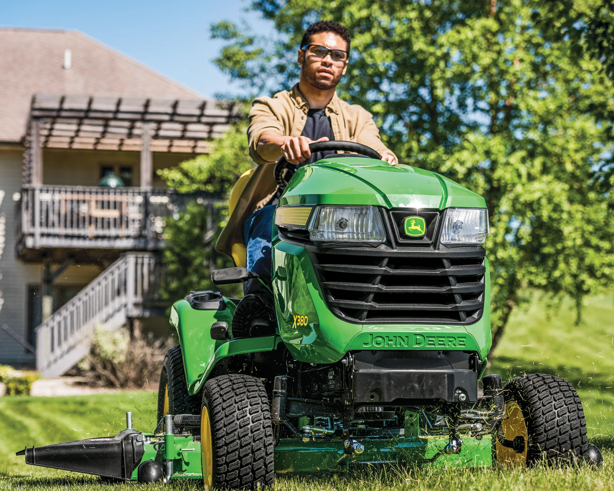 John Deere Select X300 Series Garden Tractor X380-48 John Deere Select X300 Series Garden Tractor X380 54 Front View Left Man Mowing Grass product image