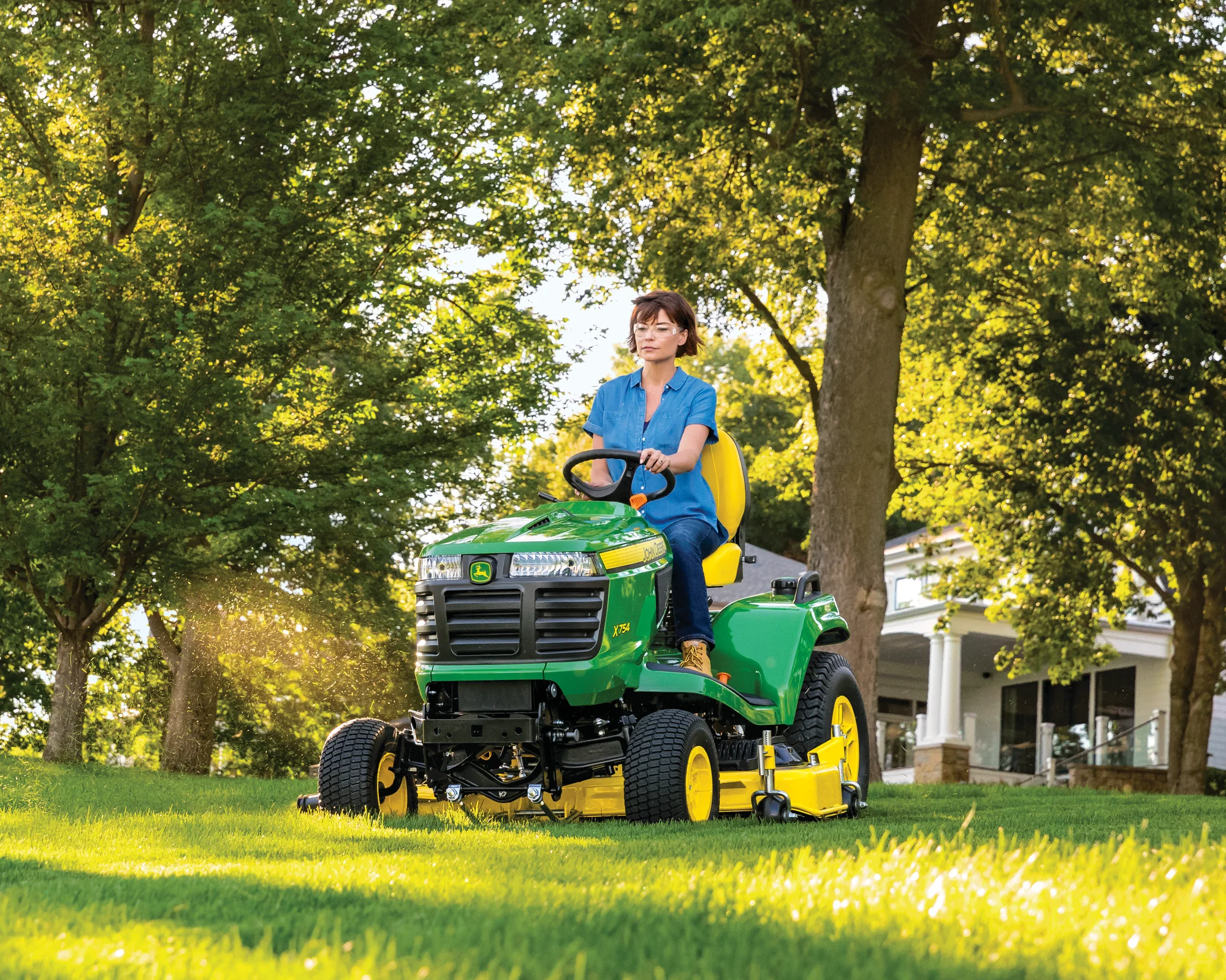 John Deere Signature X700 Series Garden Tractor X754 Front View Right Woman Mowing Lawn product image
