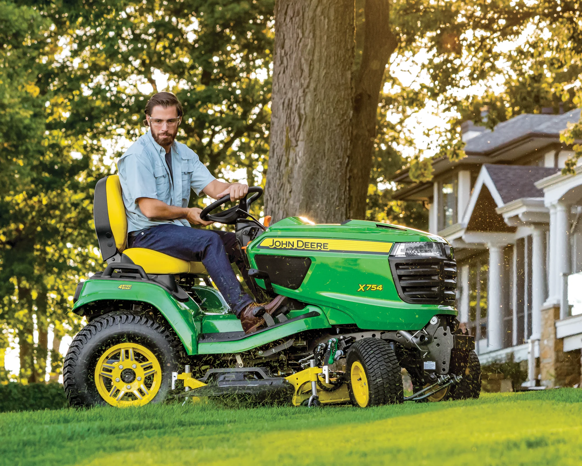 John Deere Signature X700 Series Garden Tractor X754 Side View Left Man Mowing Grass product image