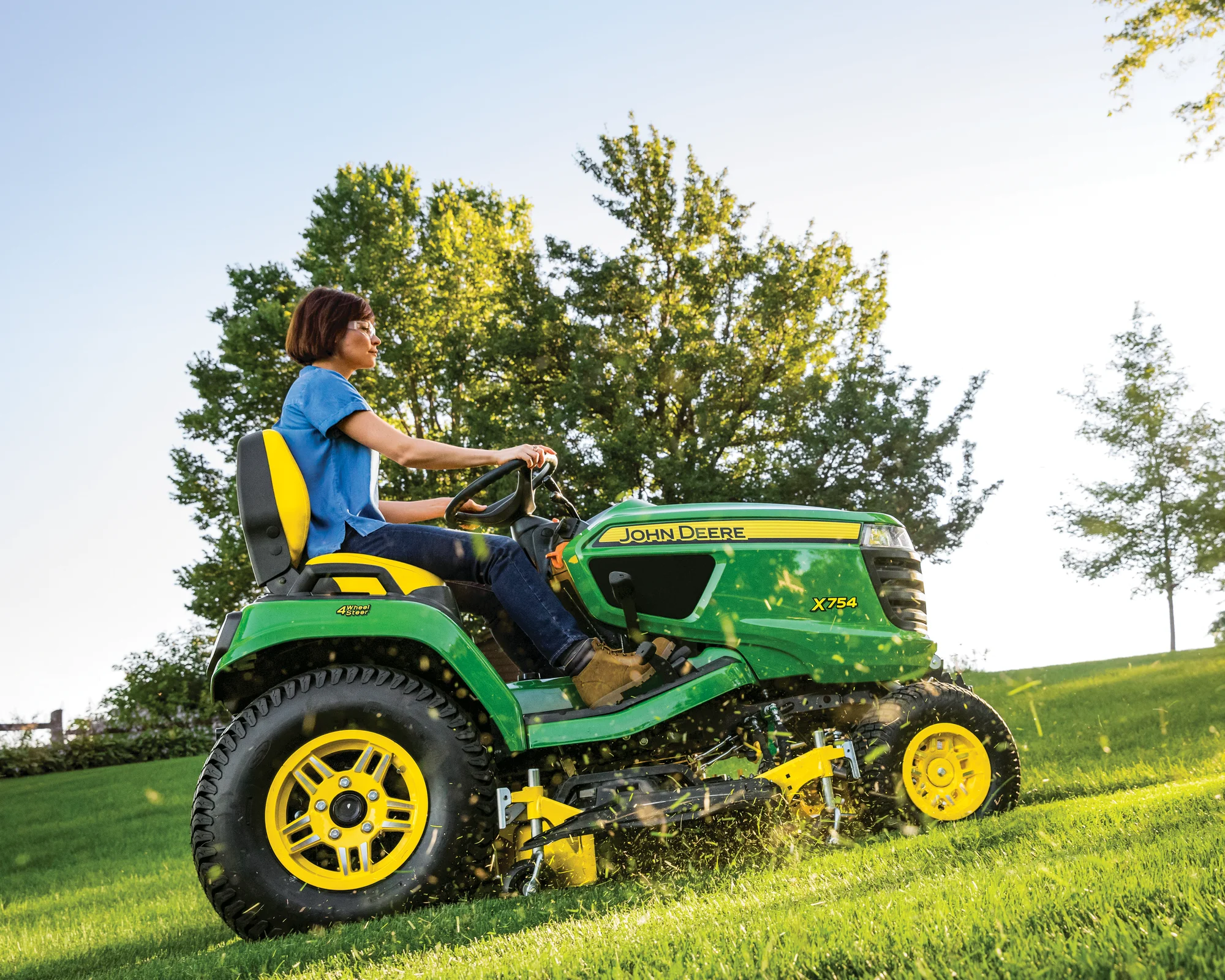 John Deere Signature X700 Series Garden Tractor X754 Side View Left Woman Mowing Grass product image