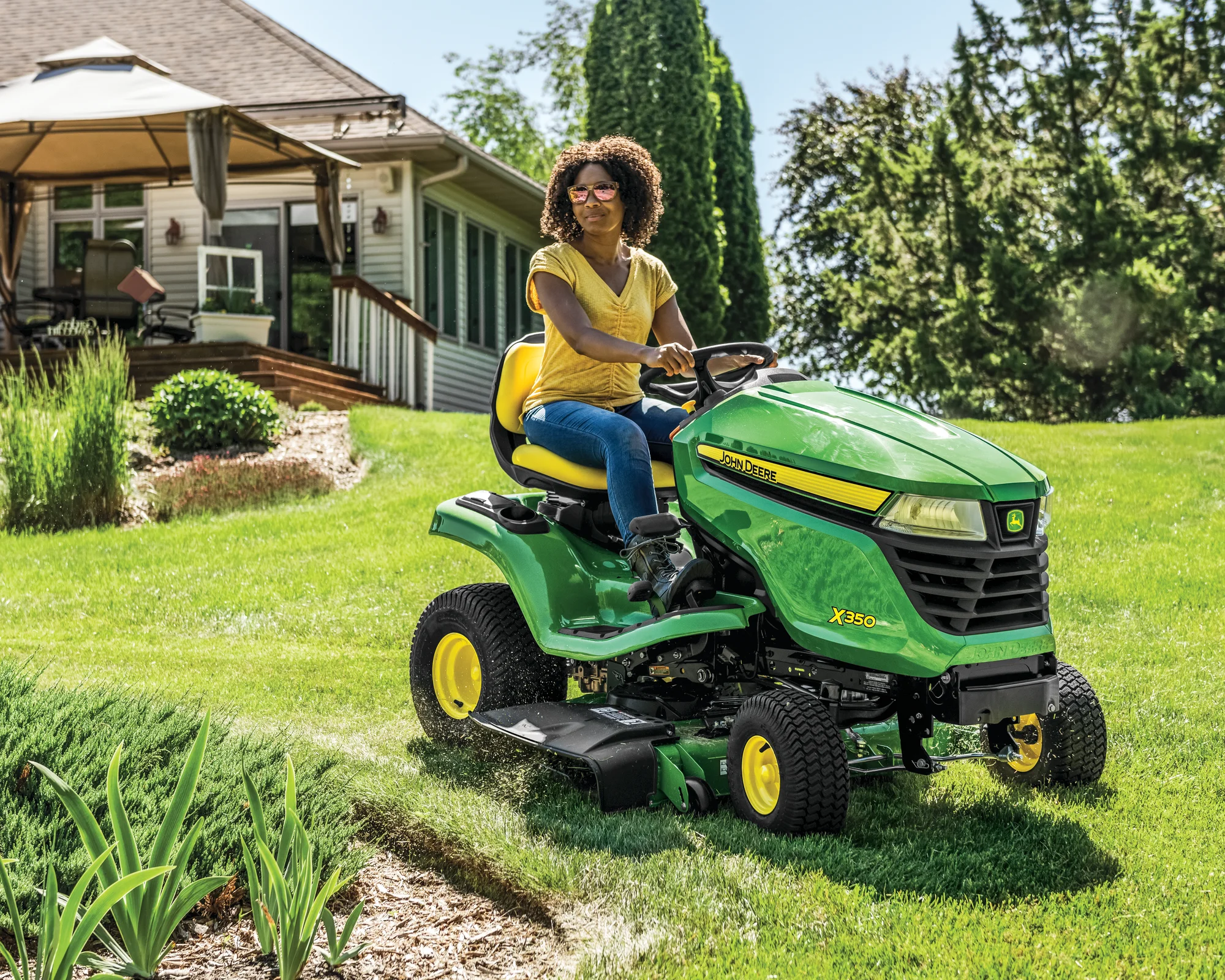 John Deere Select X300 Series Lawn Tractor X350R-42 John Deere X300 Series Select Lawn Tractor X350 Woman On Tractor Mowing Grass product image