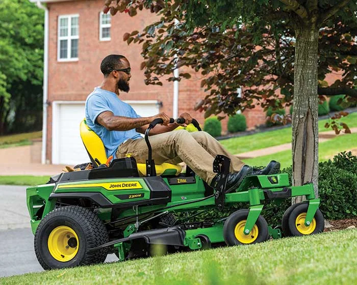 John Deere ZTrak 300 Series Zero Turn Rider Z330M-48 John Deere Ztrak 300 Series Zero Turn Rider Z330M 48 Man Mowing Lawn product image