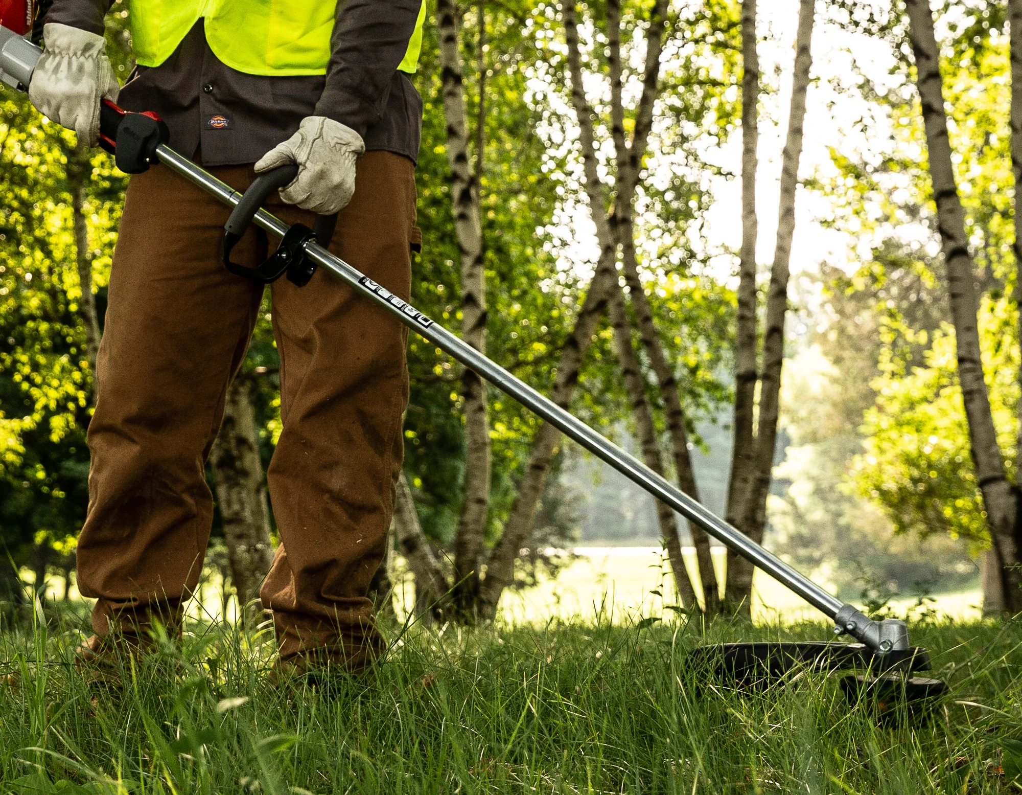 Shindaiwa T Series Trimmer T302 Lifestyle Side View Right Closeup Man Trimming Grass product image