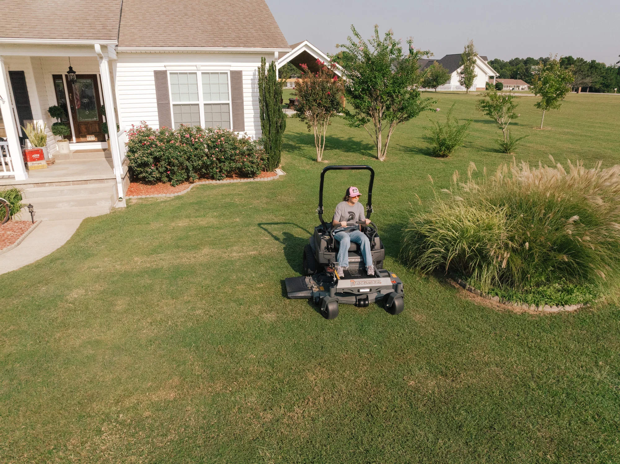 Spartan Defender Zero Turn Rider SZDE1K54691KR Spartan Defender Zero Turn Rider Szde1K54691Kr Woman On Mower Overhead Front product image